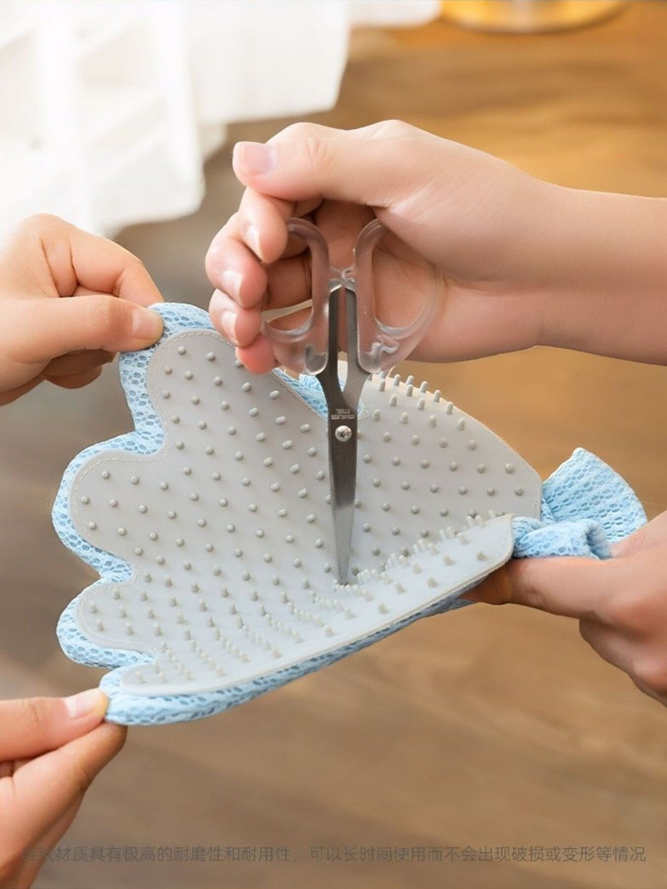 Blue bear pet hair remover glove held open, bristles facing up