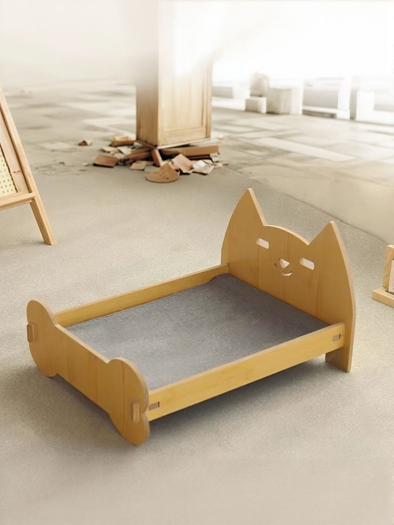 Empty wooden pet bed with gray cushion and curved side panels.