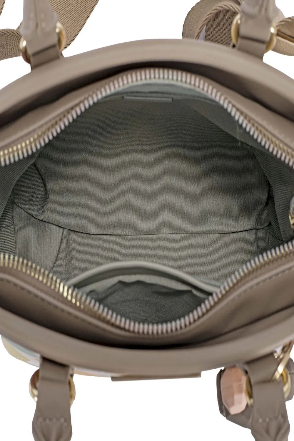 Interior view of almond milk polka dot handbag with fabric lining and zip closure