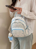 Pastel blue cartoon cat backpack with top handle, front zip pocket, and keychain charm