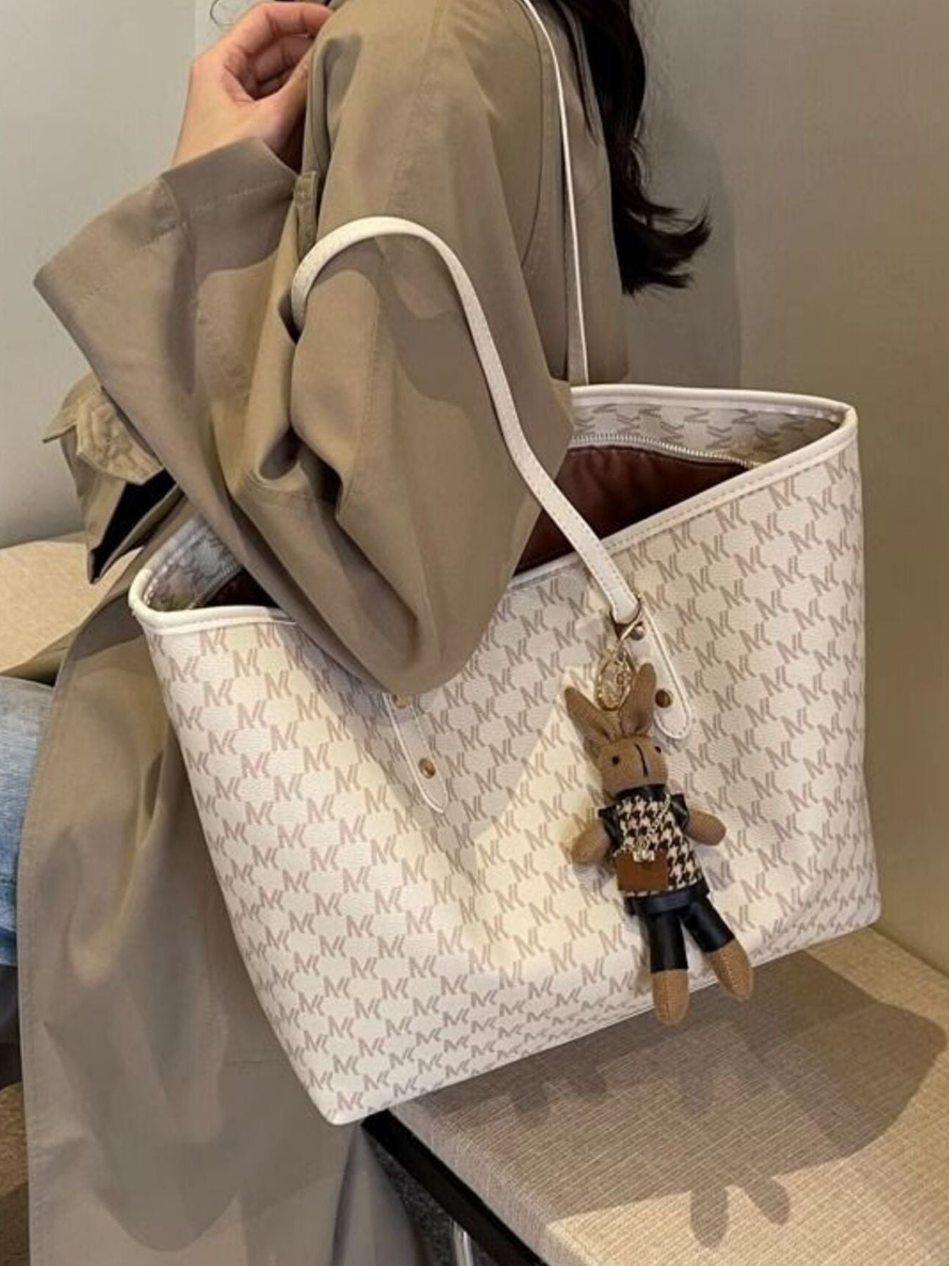 Large beige tote bag with monogram canvas, double handles, hanging rabbit charm