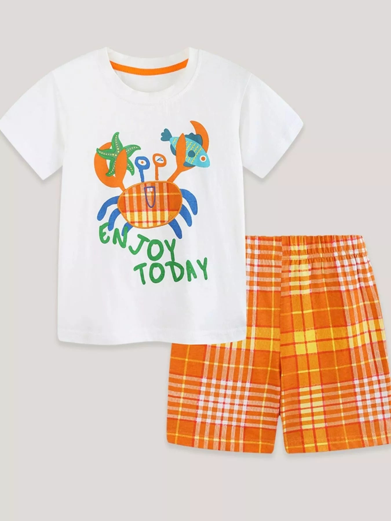 White tee with crab “ENJOY TODAY” print paired with orange plaid shorts, tangerine color