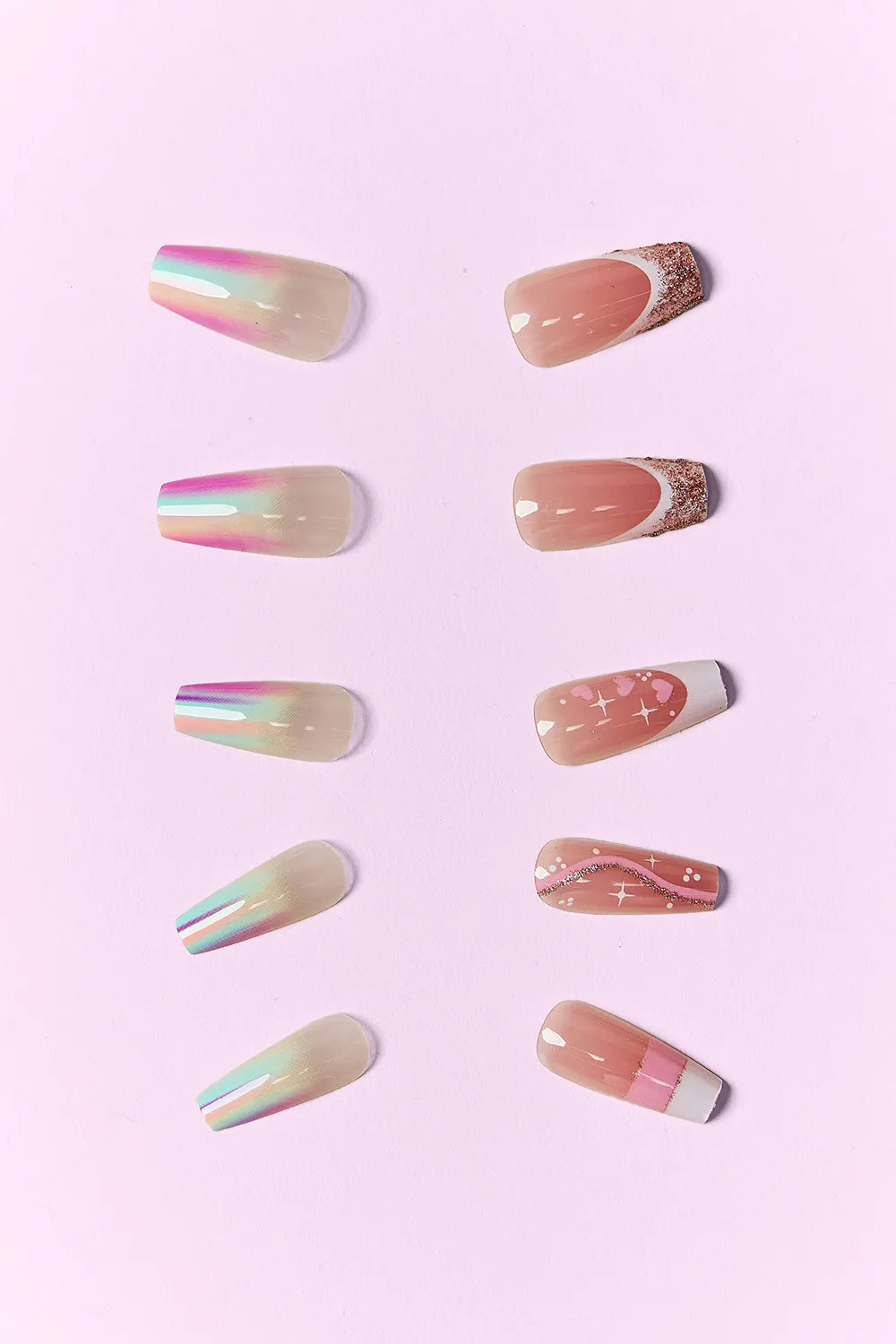 Lover Girl press-on nails, nude base with rainbow stripes and small gold star details