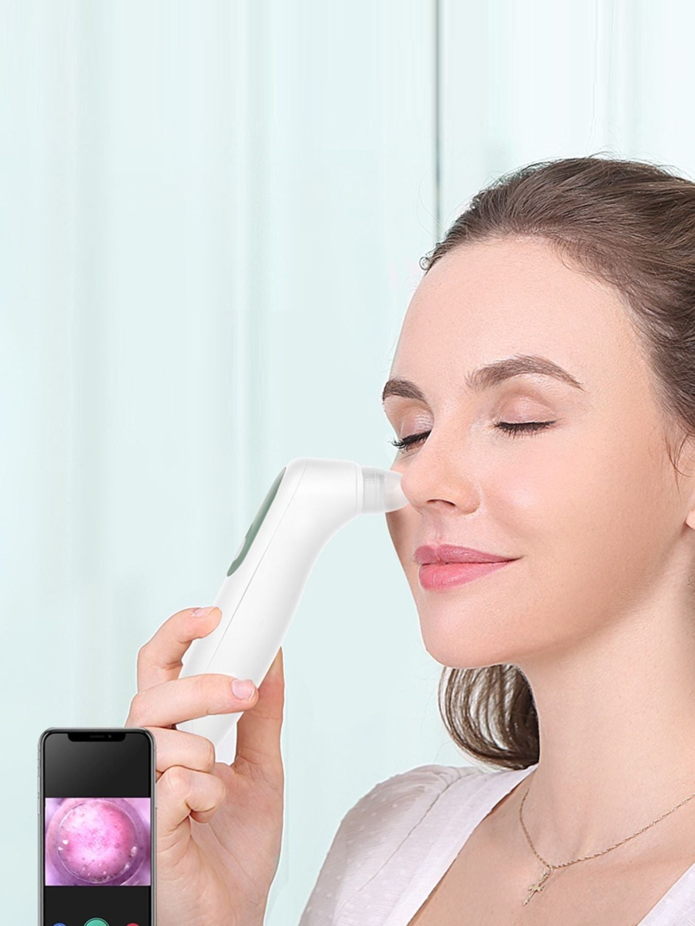 White pore vacuum blackhead extractor held to the nose with suction tip visible