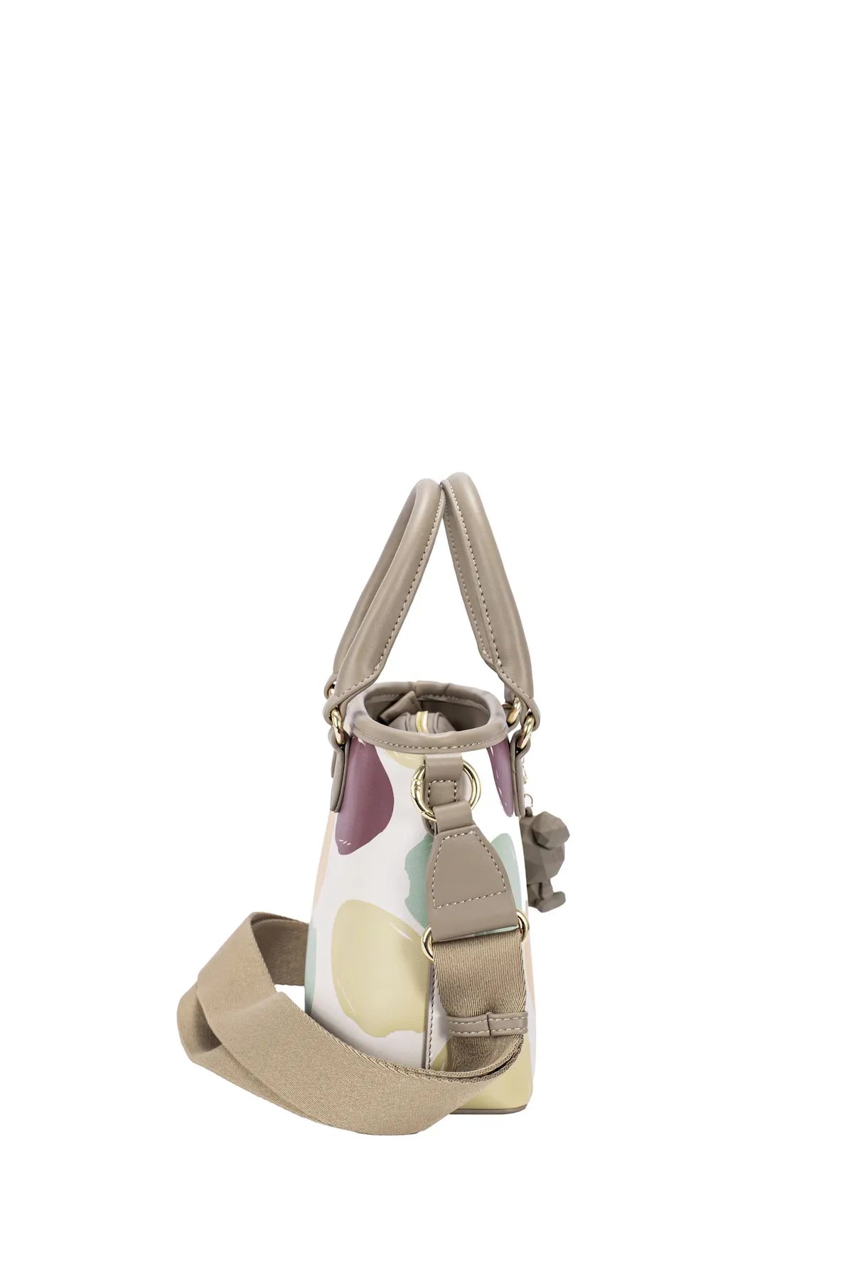 Side view of colorful polka dot handbag with top handles and crossbody strap