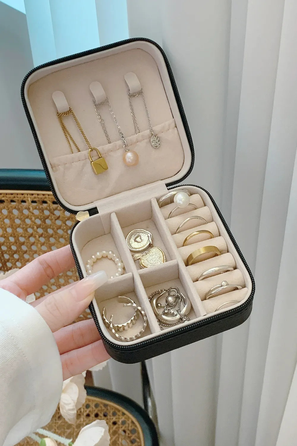 Black PU leather square jewelry box, open with earring slots and ring compartments visible.