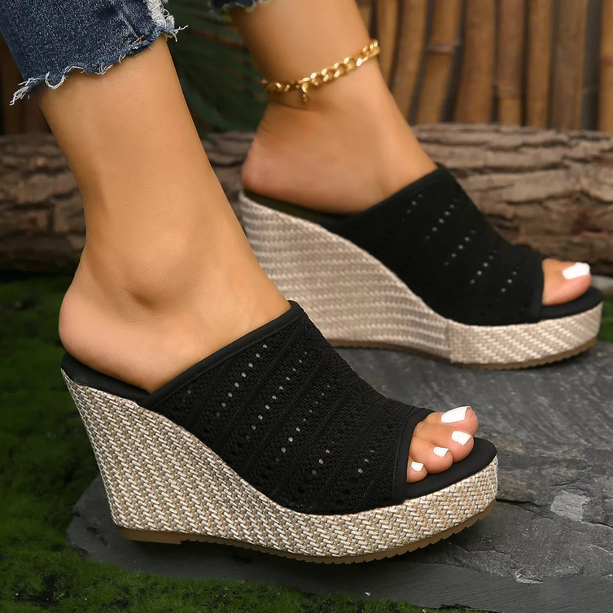 Black open-toe wedge sandals with textured knit straps and woven platform