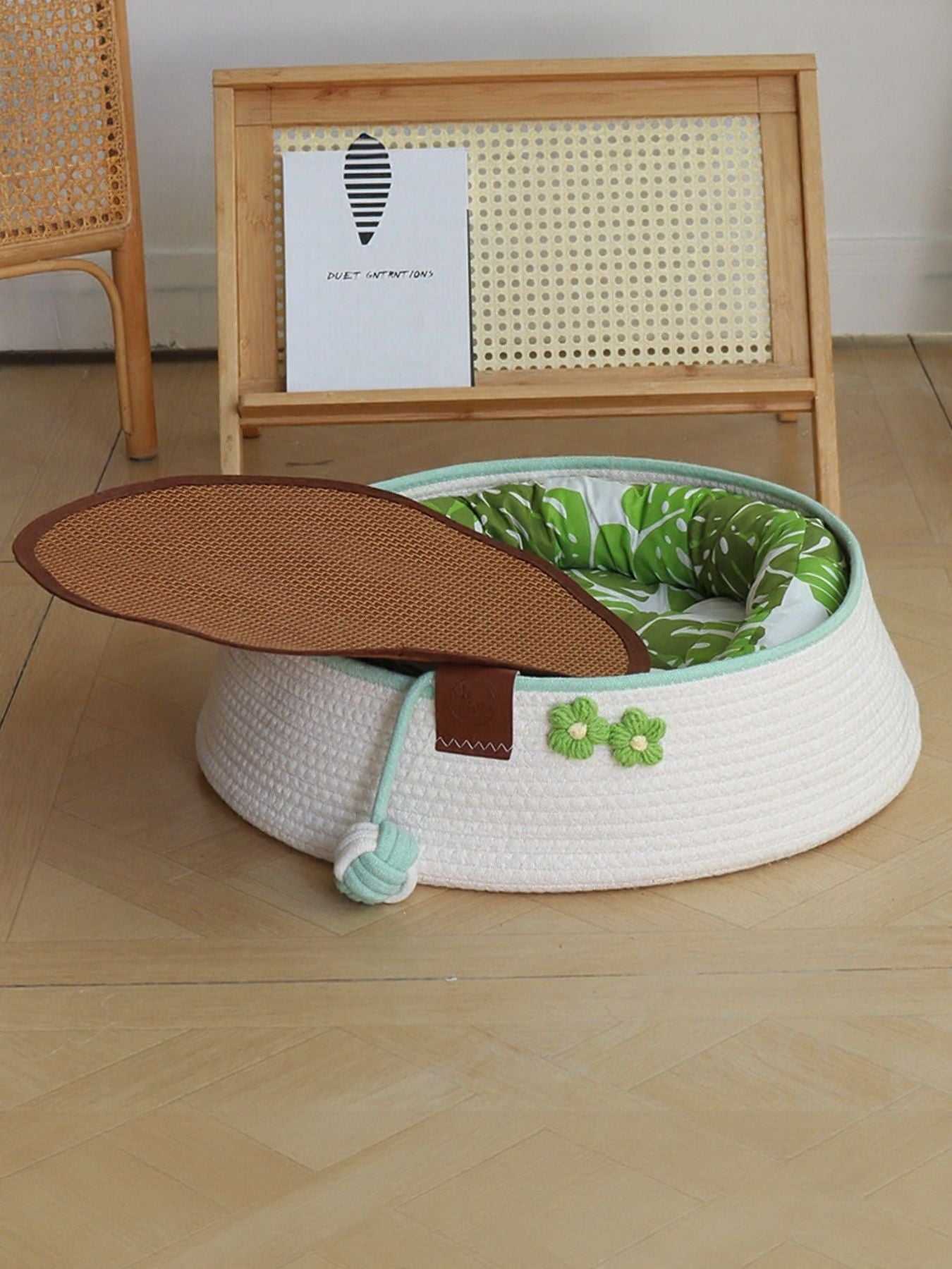 Woven pet nest in white with mint trim, clover patch, and brown detachable lid