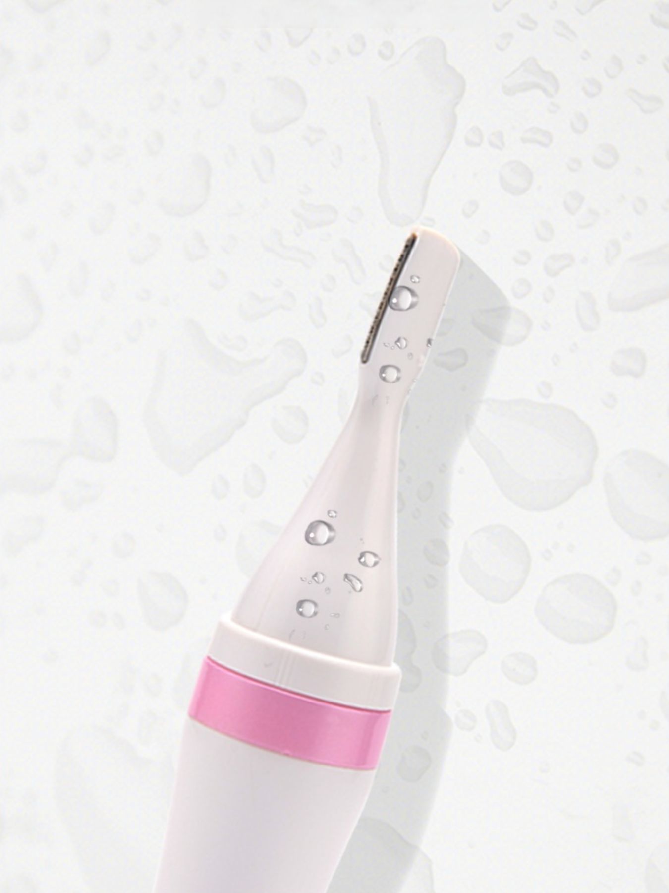 Pink 4-in-1 Nose Hair Trimmer blade head with visible water droplets