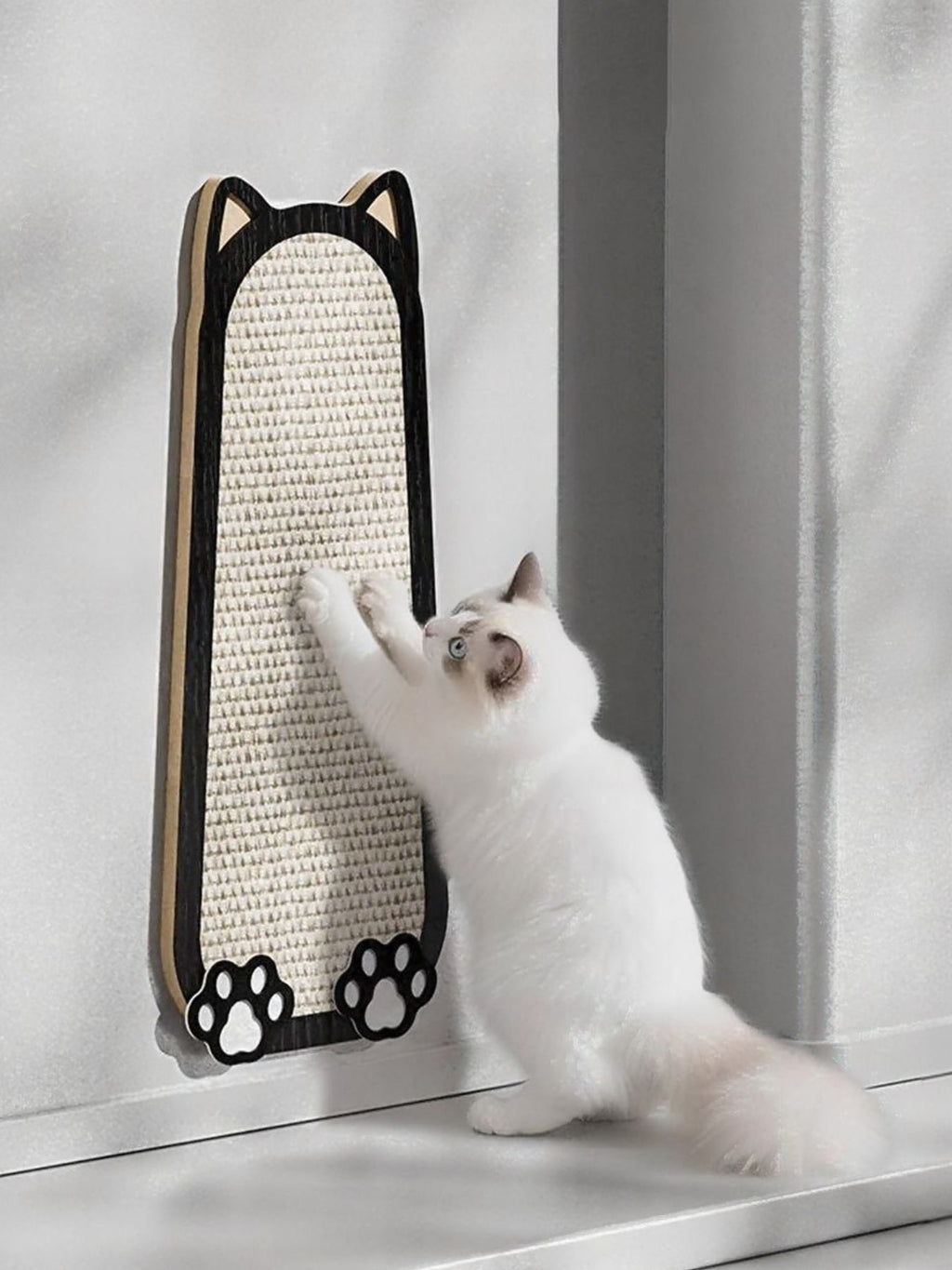 Cat-shaped scratching post with beige sisal panel and black cat-ear frame