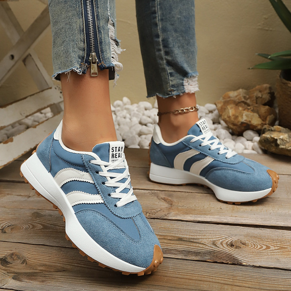 Blue suede lace-up sneakers, white laces, side stripes, chunky rubber outsole