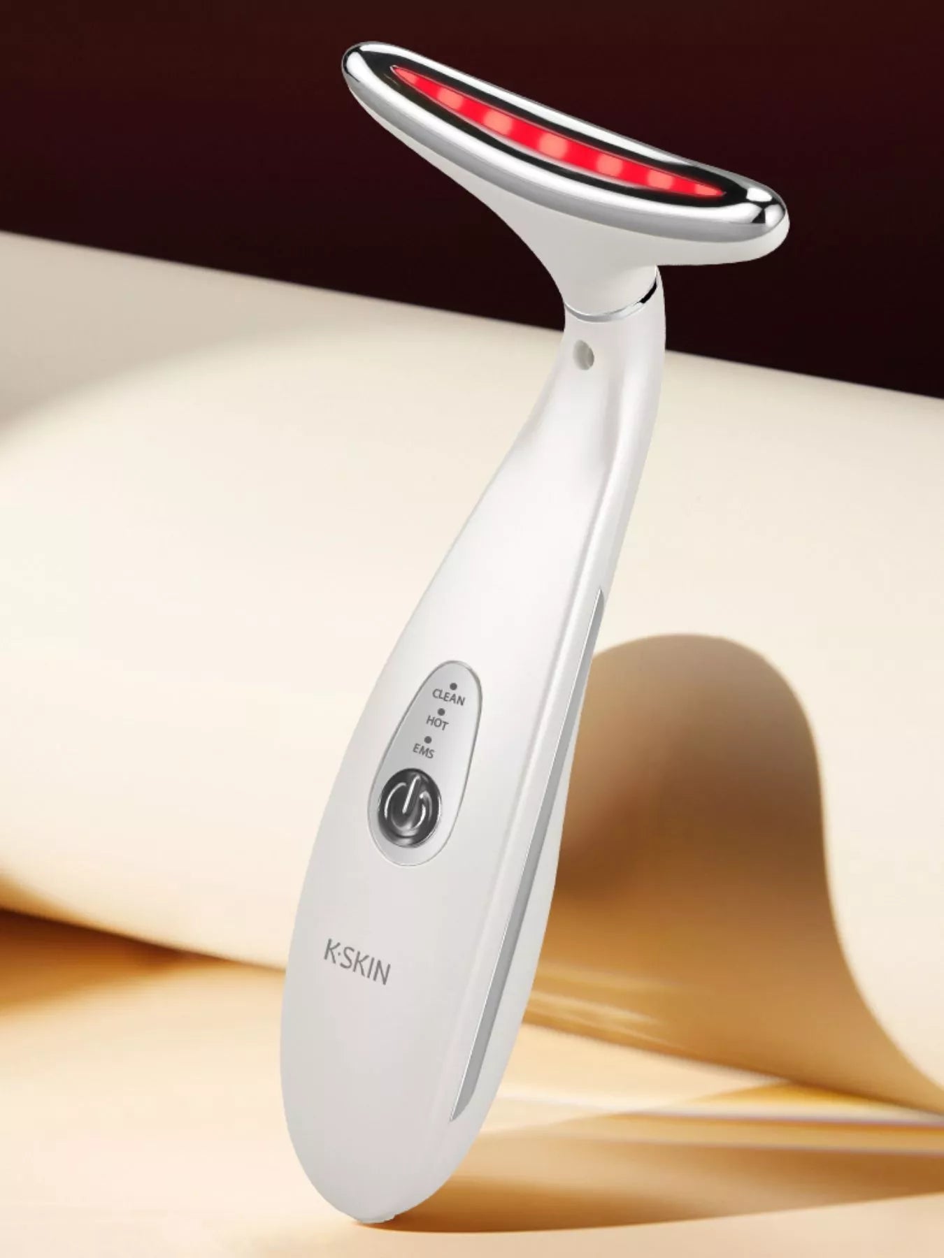 White massager handle with red LED ring and control buttons on body