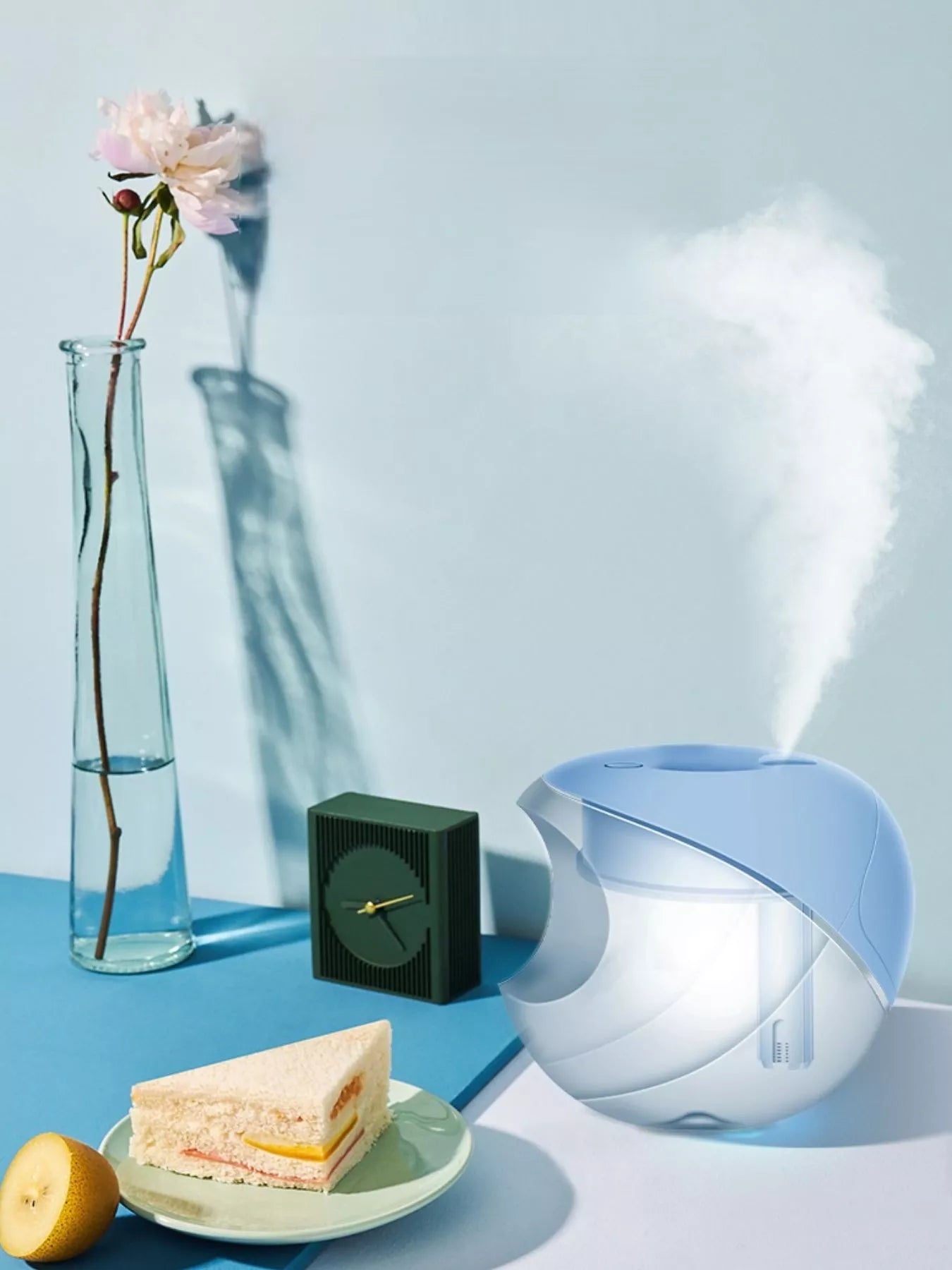 Light blue apple-shaped humidifier on a tabletop