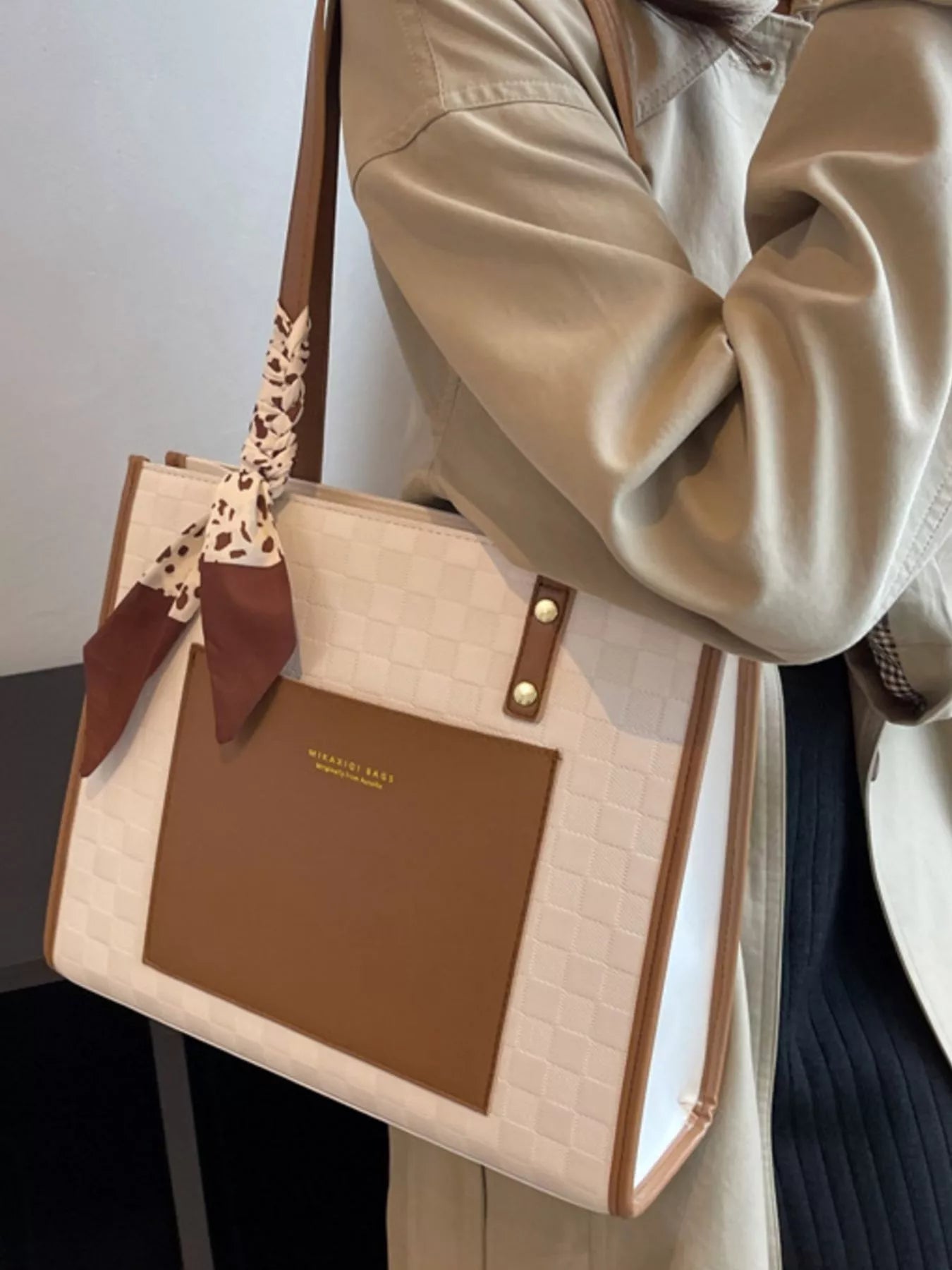 White and brown color block shoulder bag with top handles and gold snaps