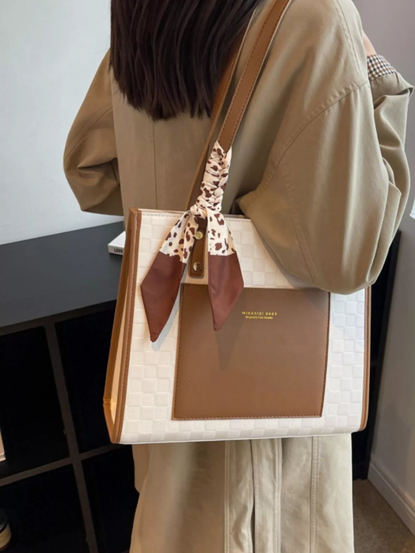 White quilted tote-style shoulder bag with brown front panel and scarf tie