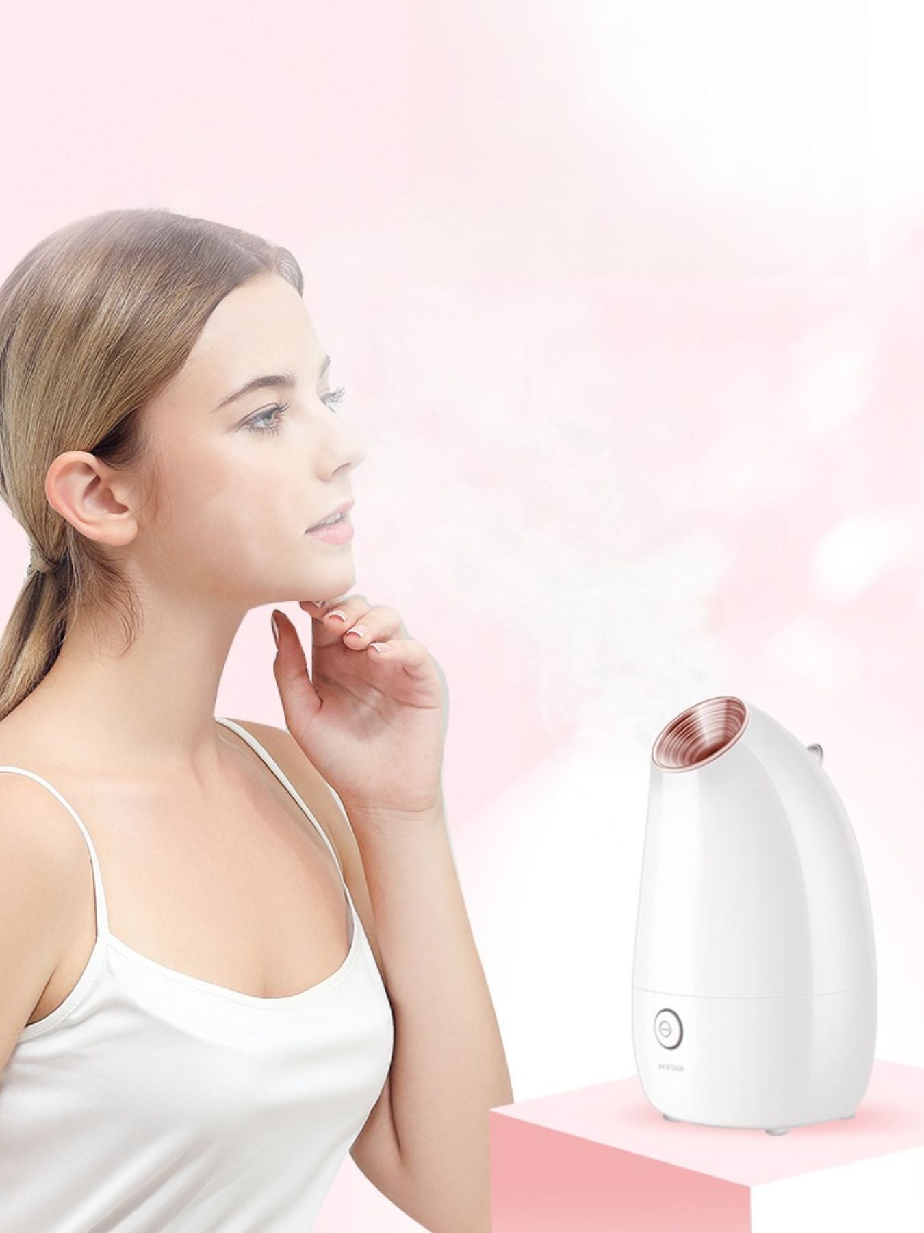 White facial steamer with rose-gold top vent; handheld use