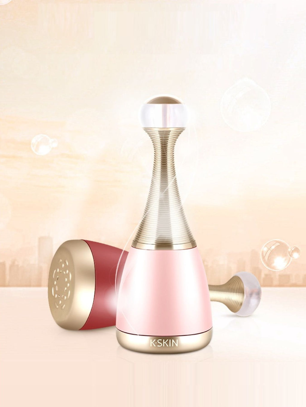 Facial steamer device in blush pink with gold nozzle and side attachment