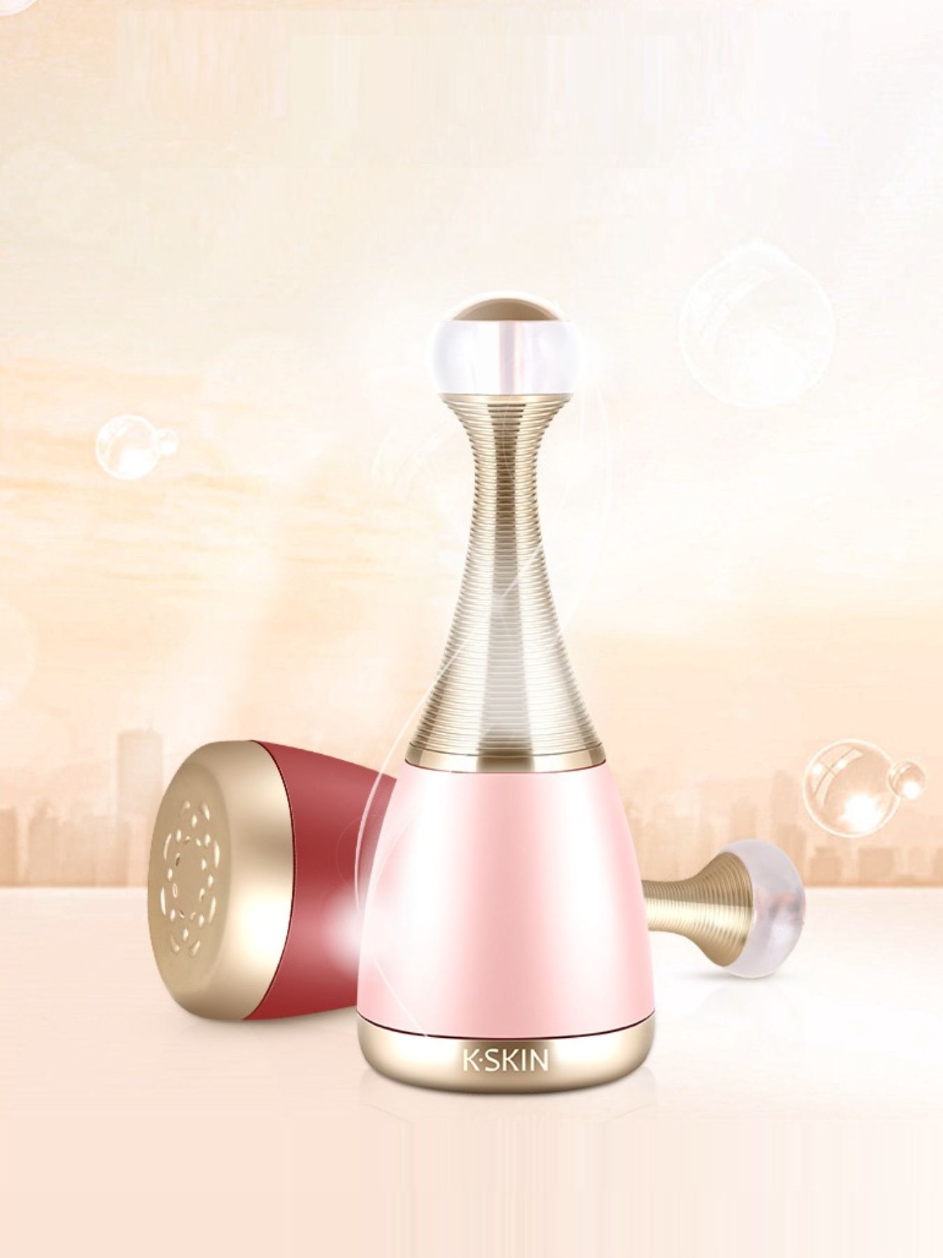 Facial steamer device in blush pink with gold nozzle and side attachment