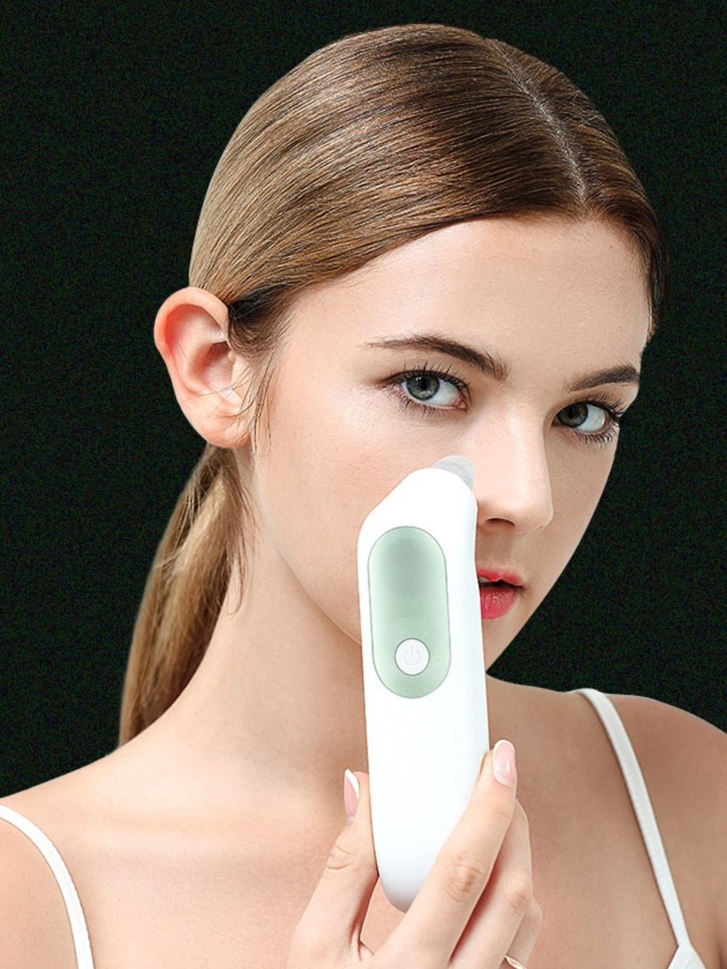 White blackhead extractor device pressed on cheek area with suction opening