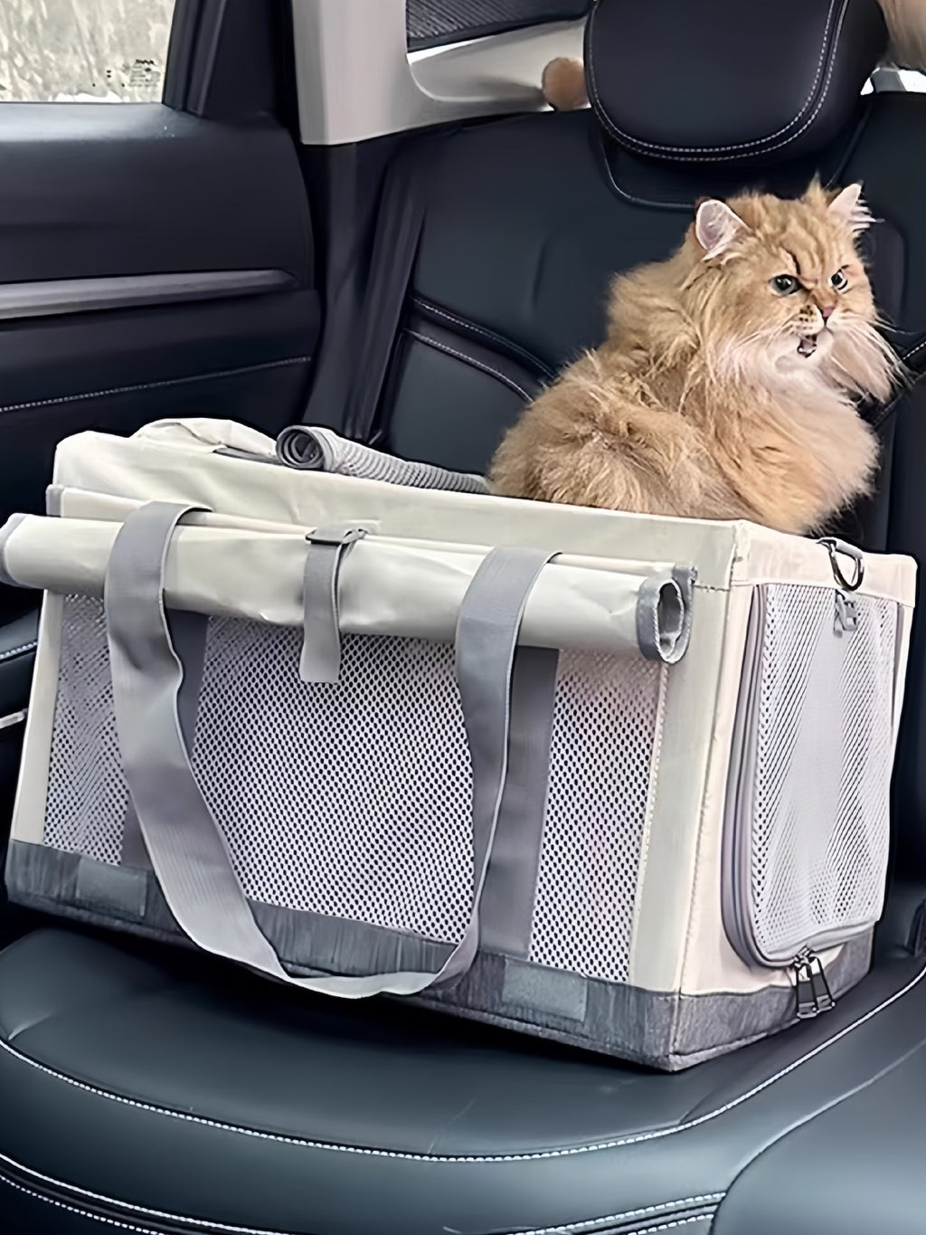 Gray pet carrier bag with zip opening, gray straps, and breathable mesh side panels.