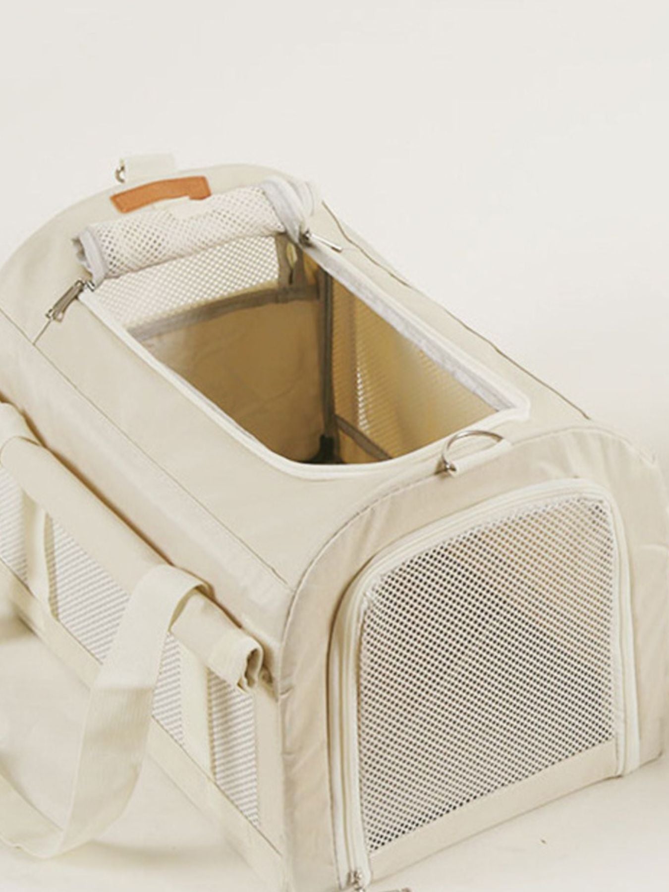 Pet carrier bag with liner and zip-open mesh door, see-through ventilation panel, white.