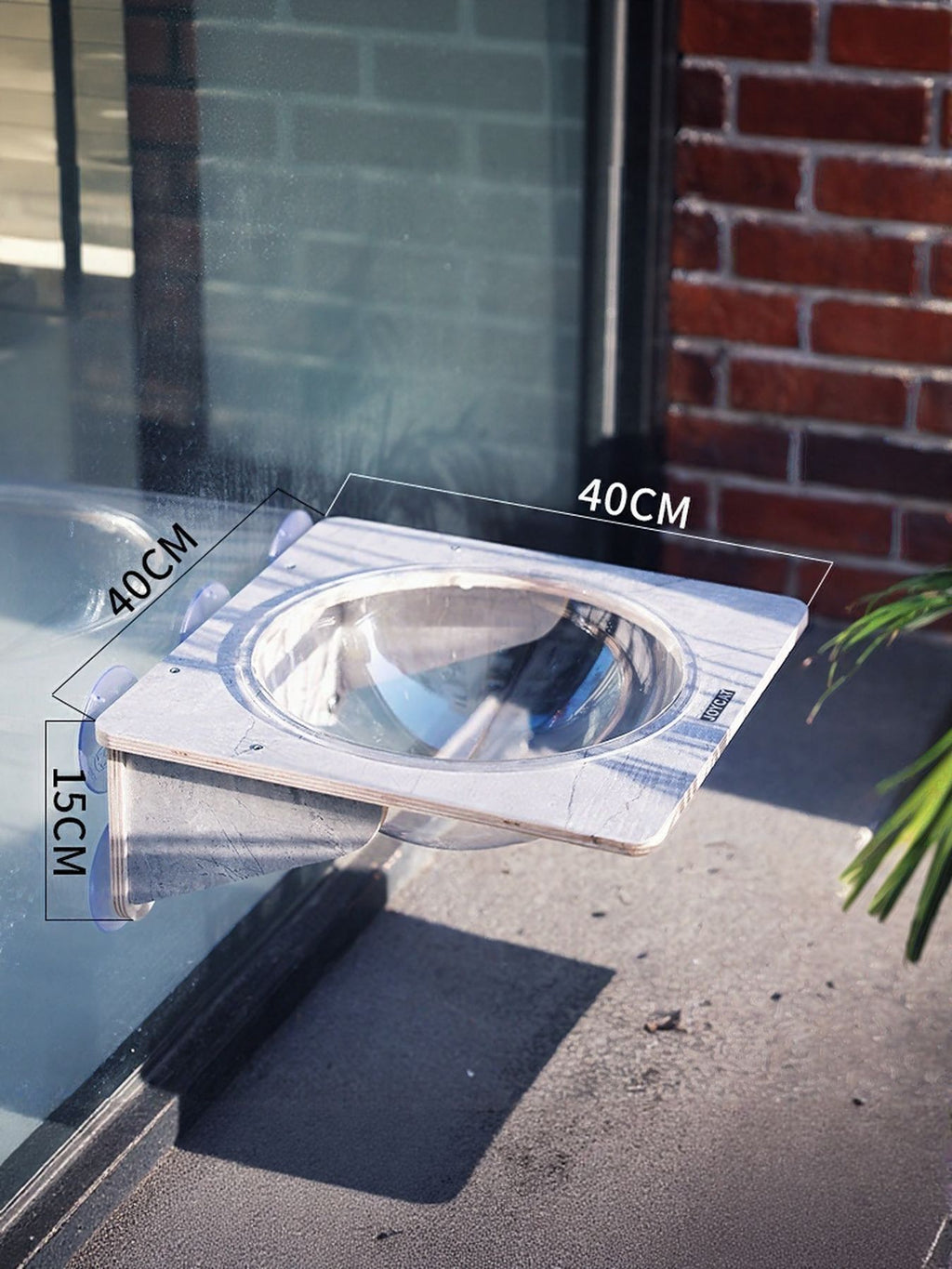 Window-mounted cat accessory with clear circular opening and grey base, with size labels