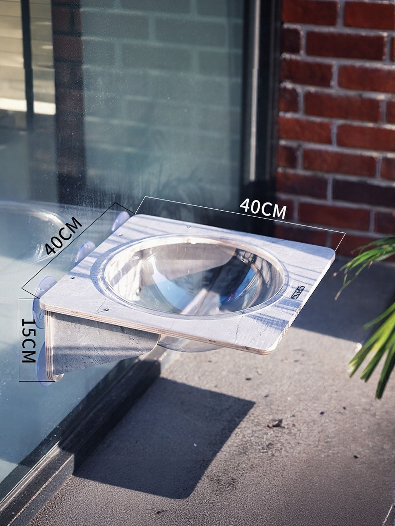 Window-mounted cat accessory with clear circular opening and grey base, with size labels