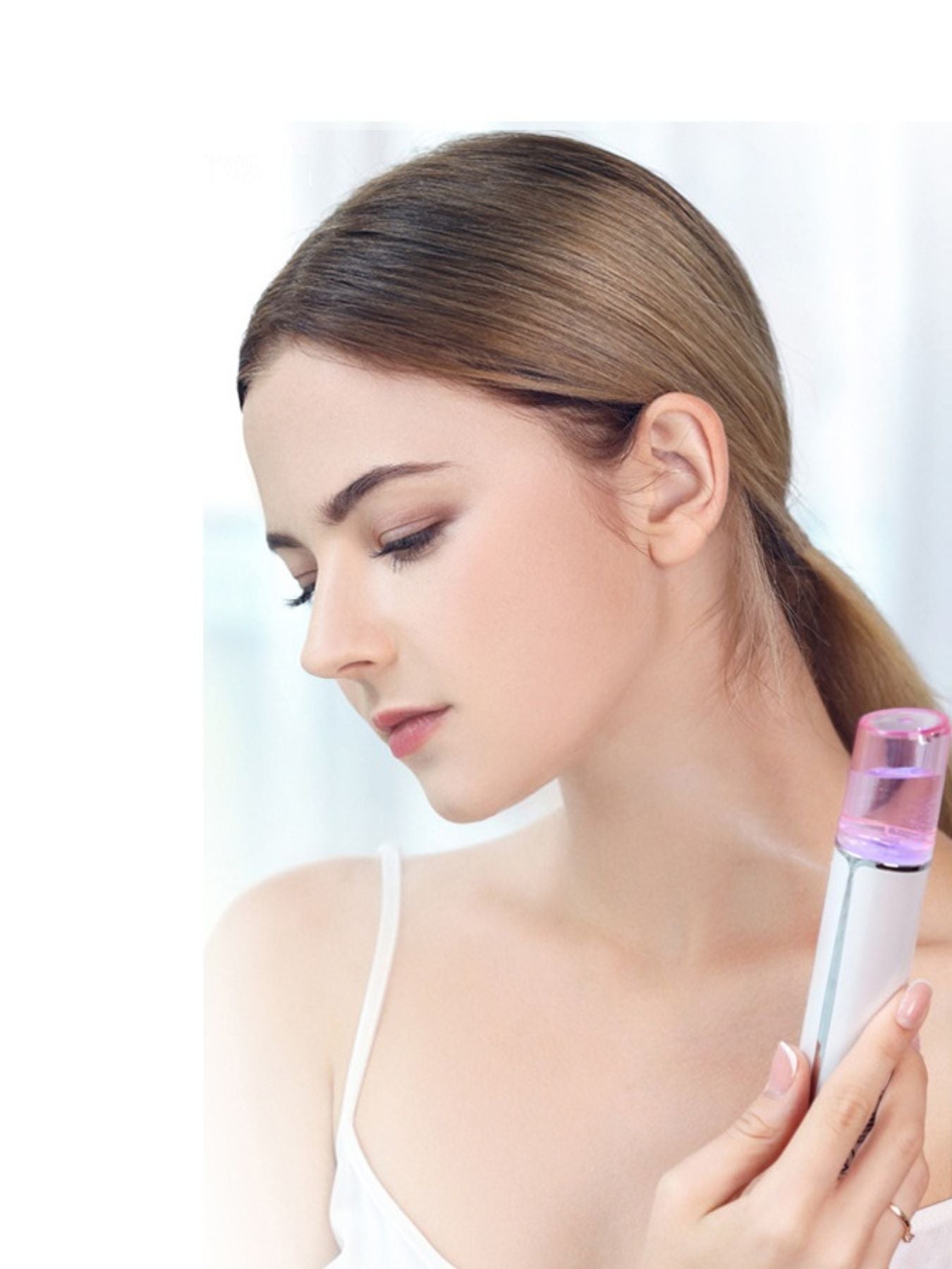 Portable facial mist sprayer dispensing mist near neck area