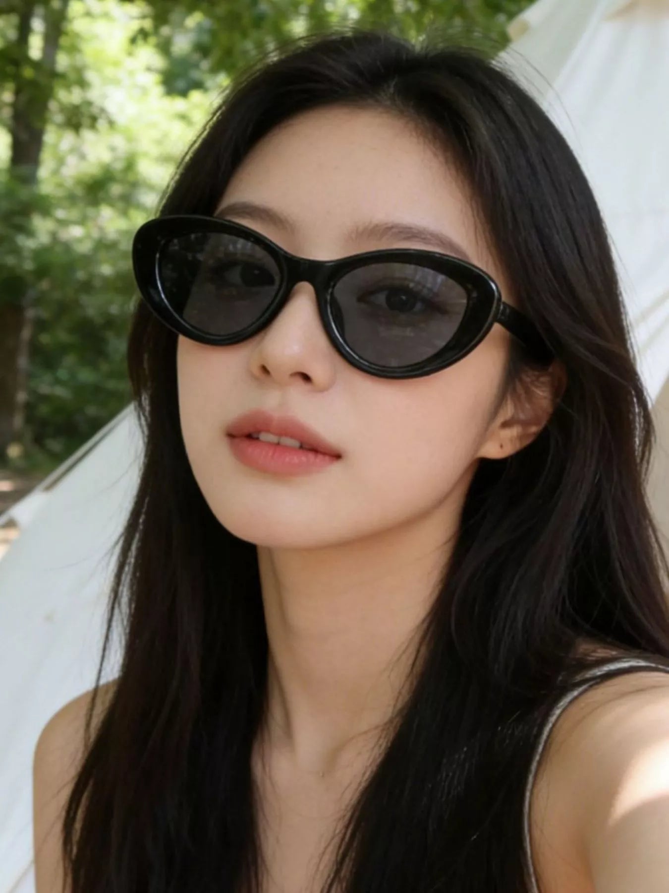 Cat-eye sunglasses, black frames with dark lenses