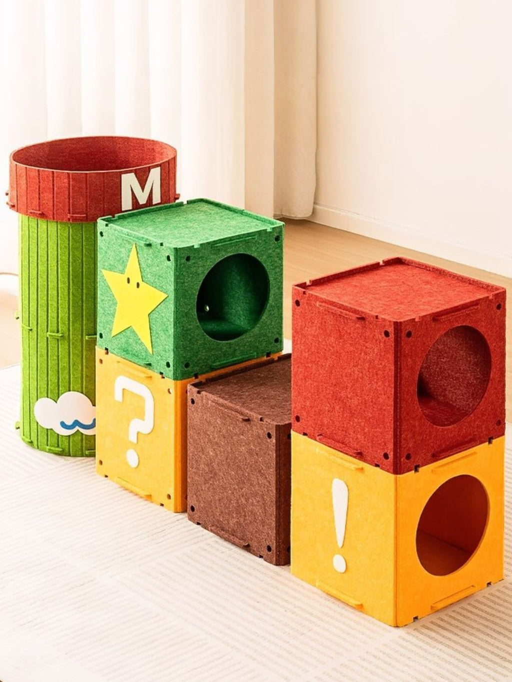 Stacked cube cat house set in green, orange, red with round entrance holes and M label