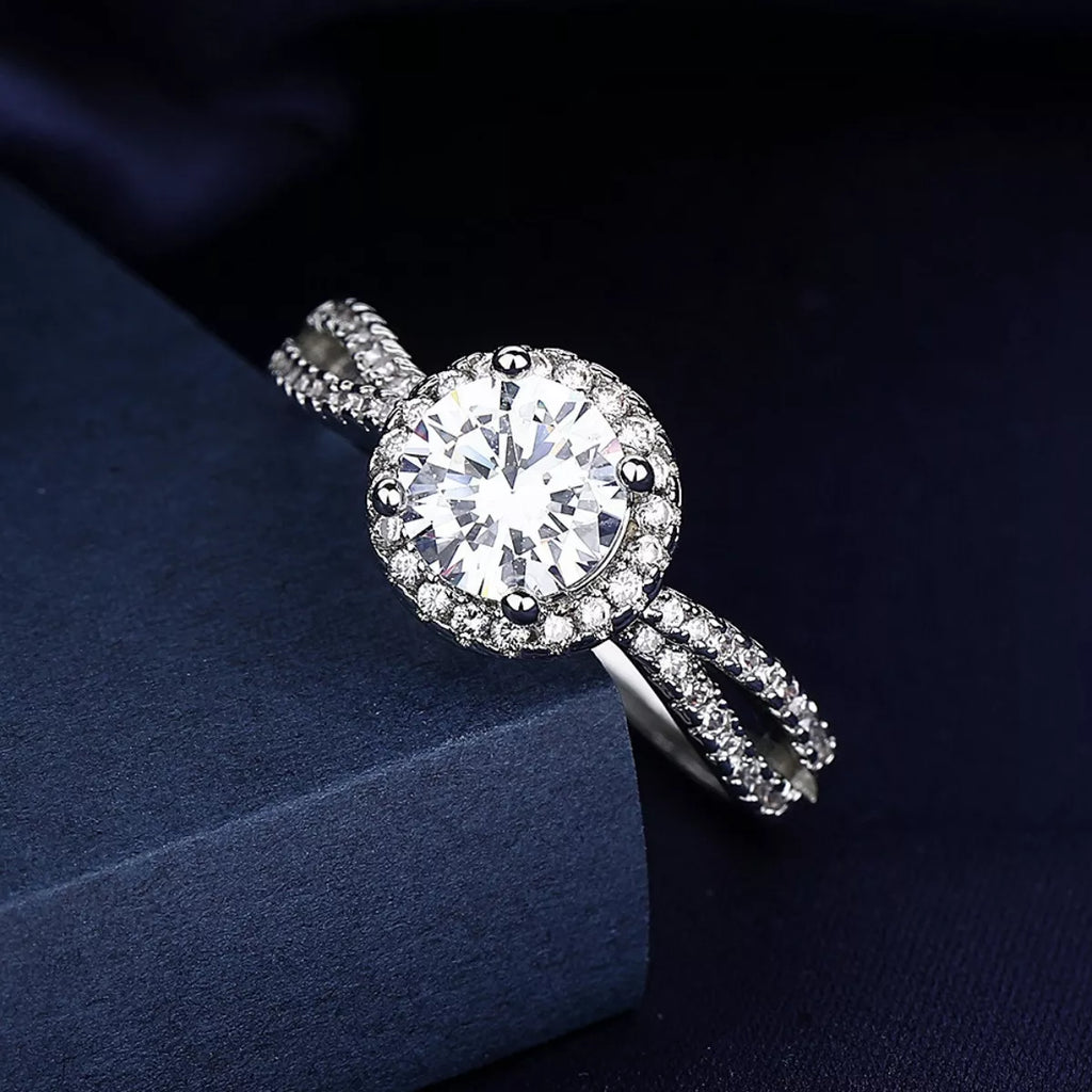 Silver moissanite halo ring with round center stone and pavé band detailing