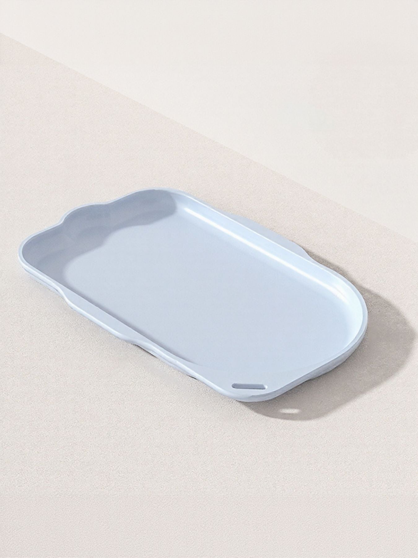 Pet bowl tray in light blue with rounded edges and recessed base