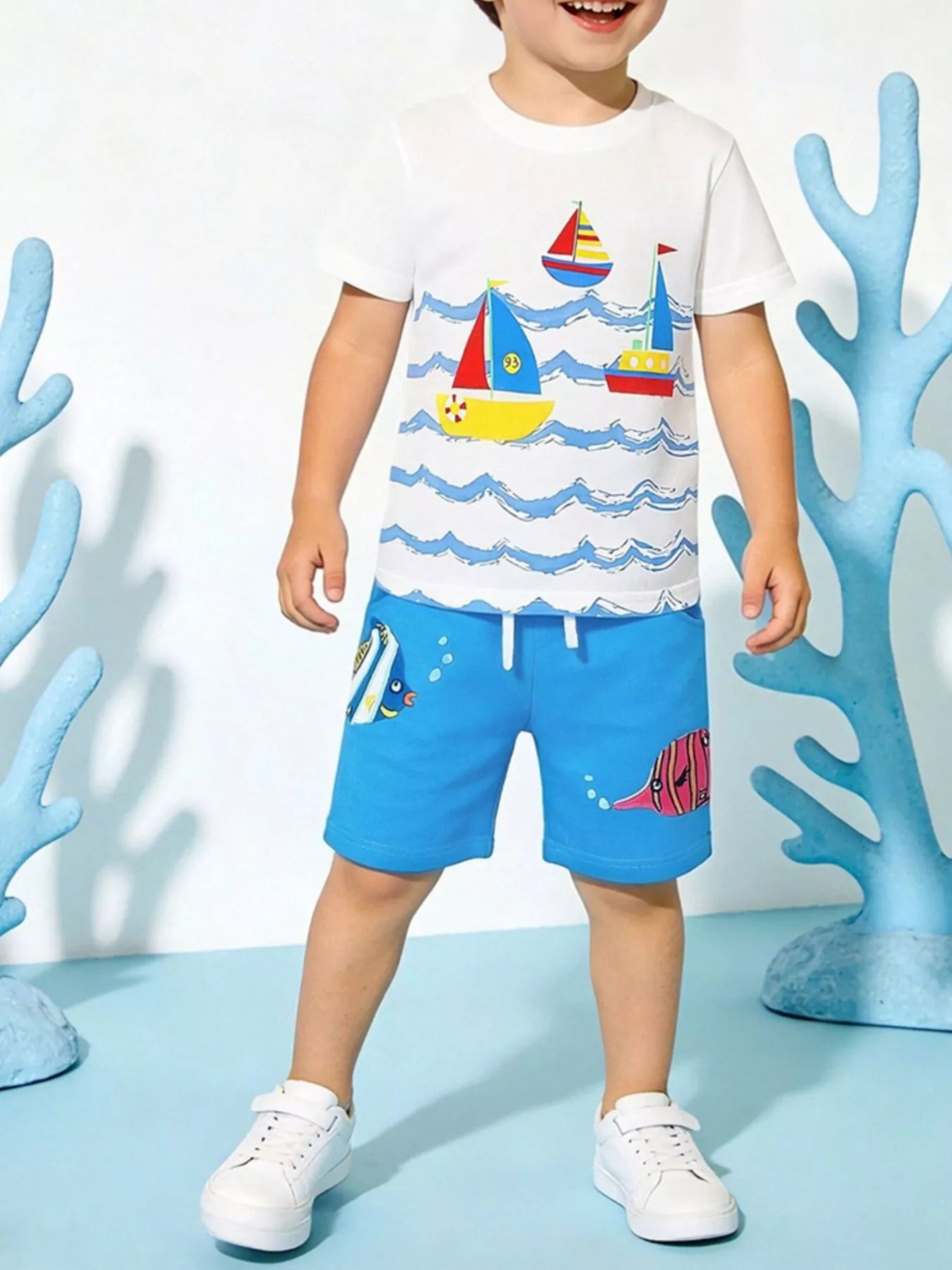 Kids nautical adventure tee and shorts set: white shirt with sailboats, blue shorts with fish
