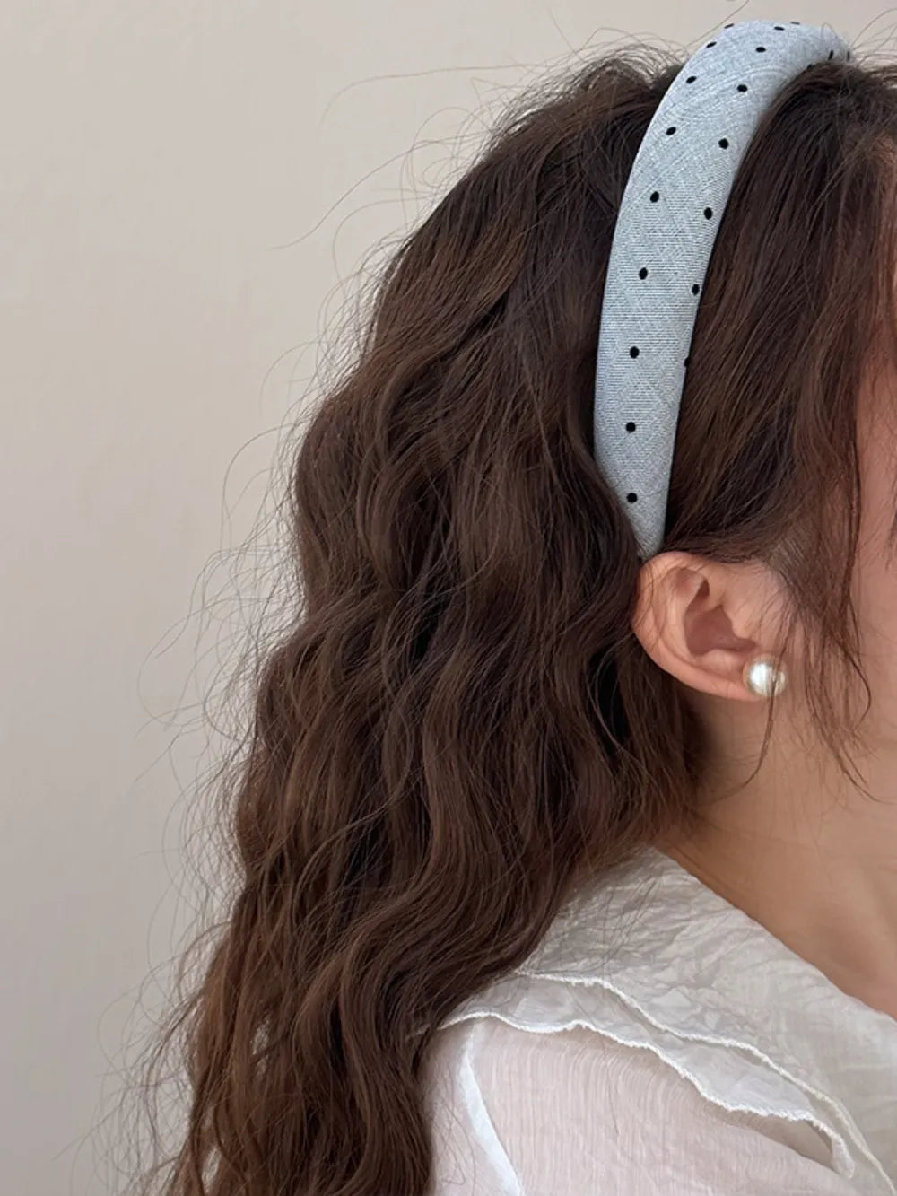 Dark gray polka dot wide headband worn, black dot pattern