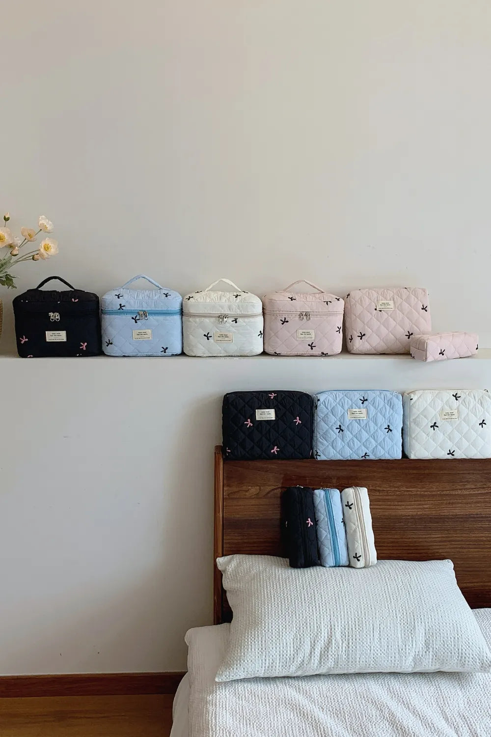 Assorted-color quilted storage bag set with bow print: small, medium, and large zip pouches