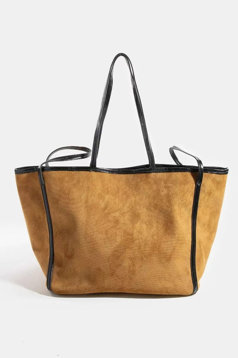 Suede tote bag with black faux-leather trim and dual top handles, tan/brown.