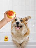 Soft Pet Shower Brush in yellow with orange bristles, held above a dog’s head