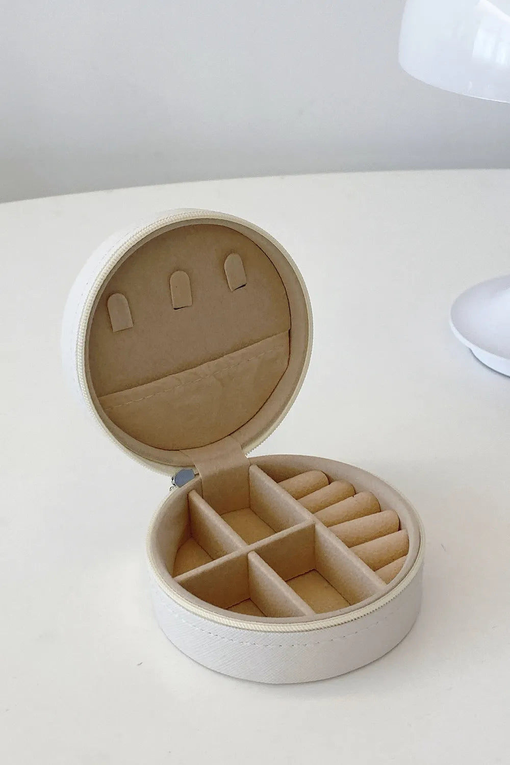 White PU leather jewelry box interior with padded dividers for bracelets and rings