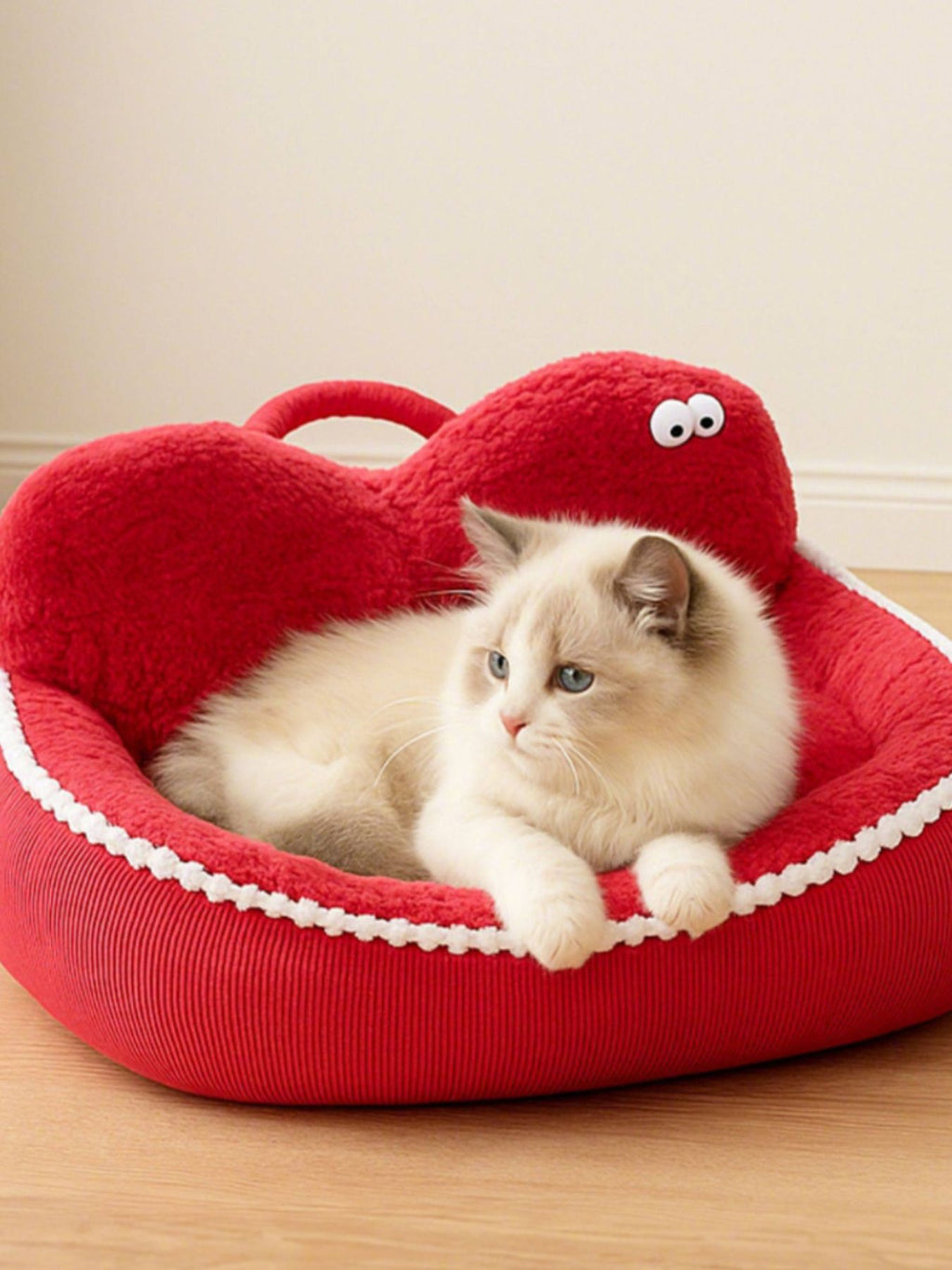 Apple-red cartoon pet nest with plush lining and side handle, cat sleeping