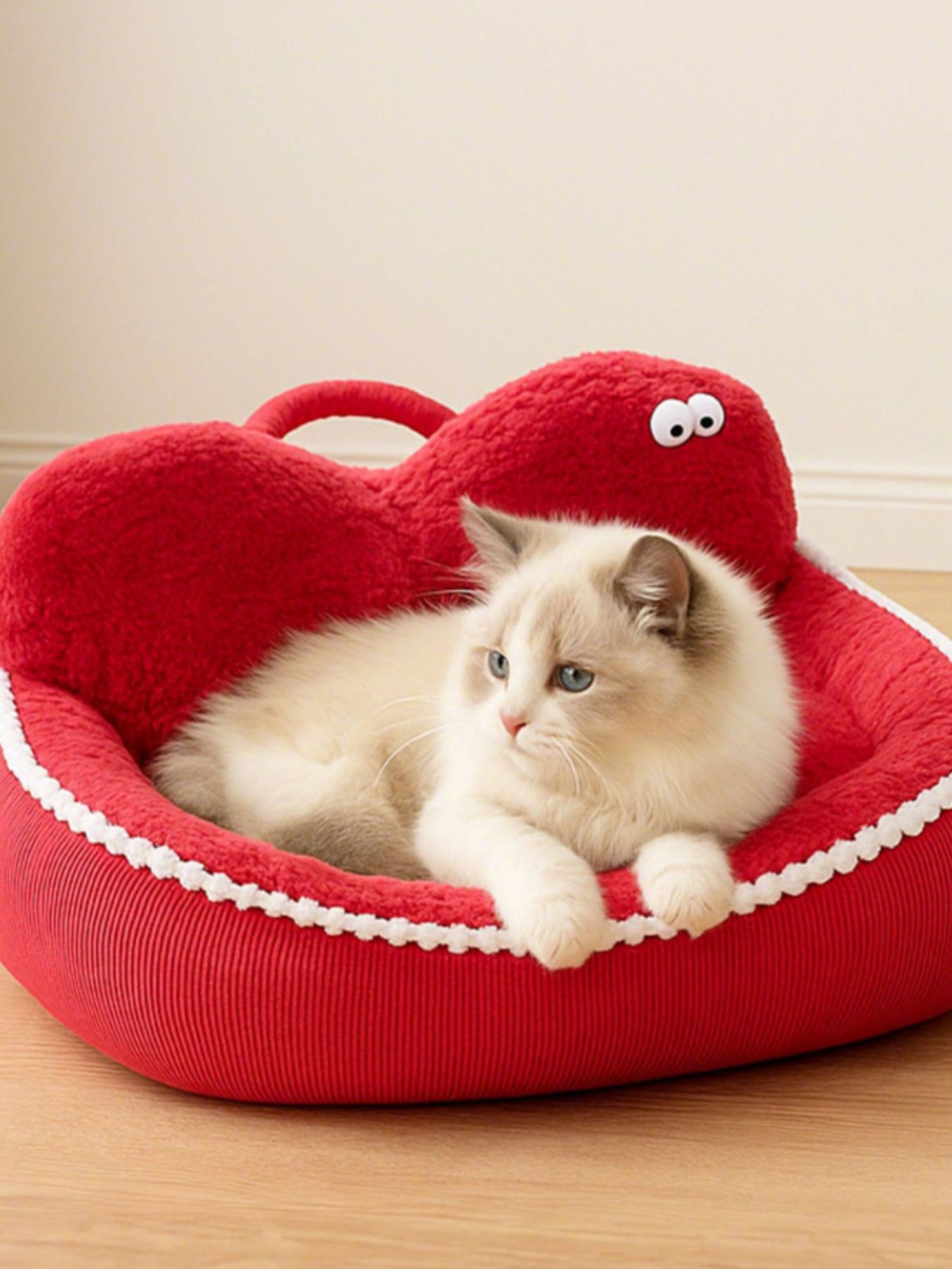 Apple-red cartoon pet nest with plush lining and side handle, cat sleeping