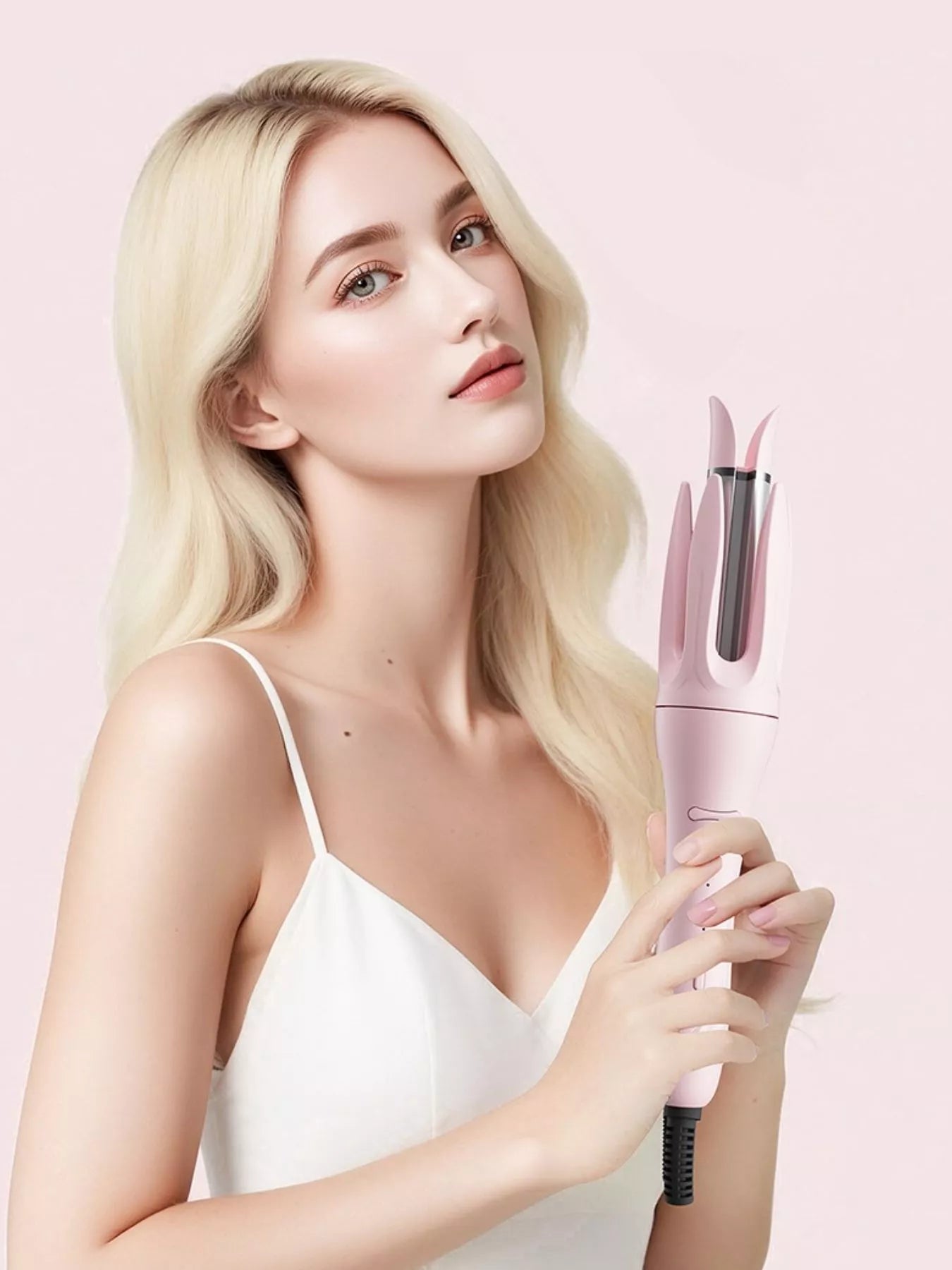 Blonde model holding a Blush Pink automatic rotating ceramic curling iron