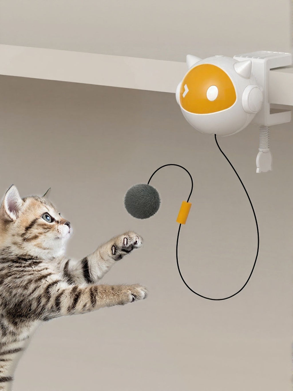 Interactive hanging cat teaser toy with yellow window ball, black cord, and gray pom ball