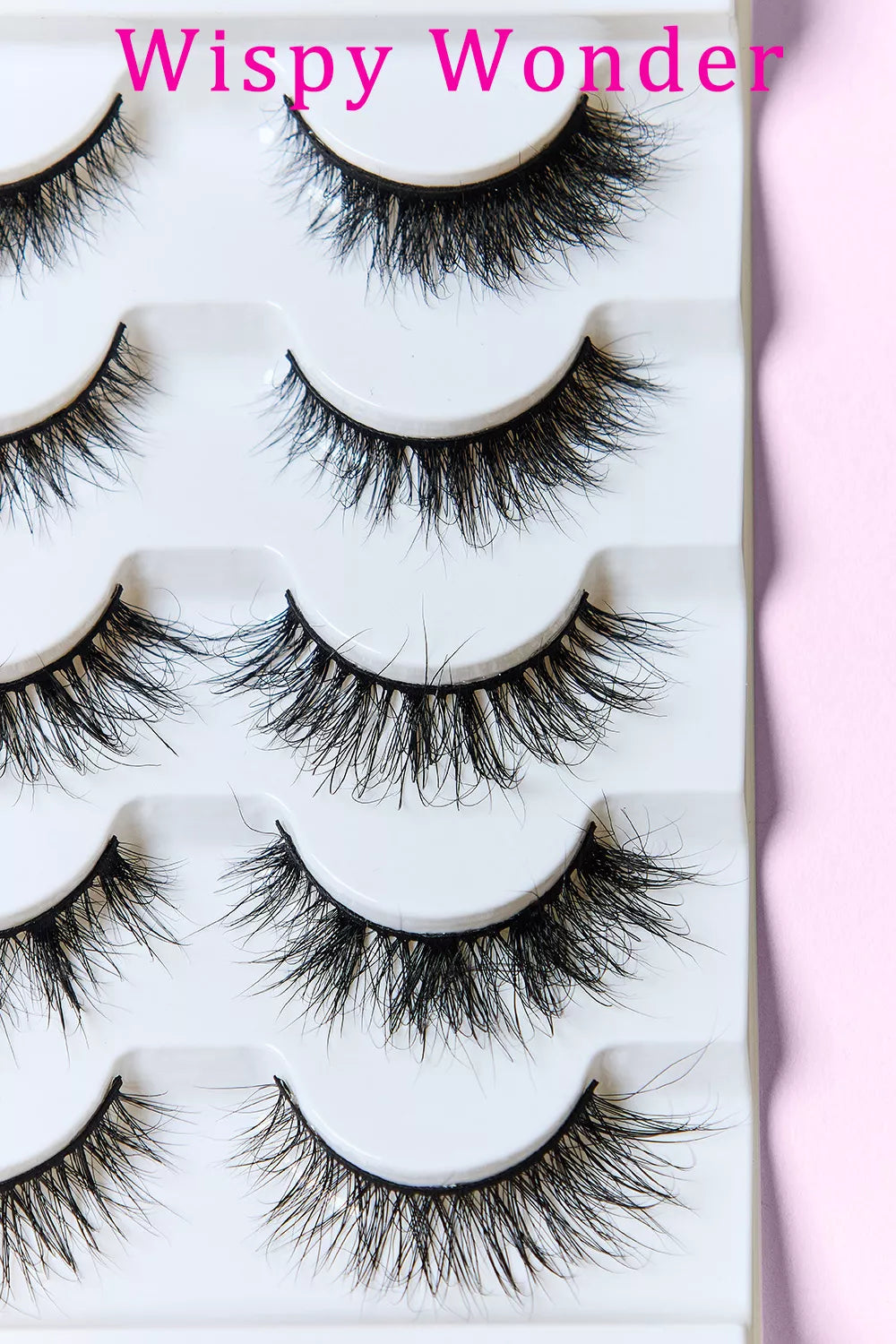 Wispy Wonder mink-look lashes shown in tray, several curved lash pairs with wispy volume