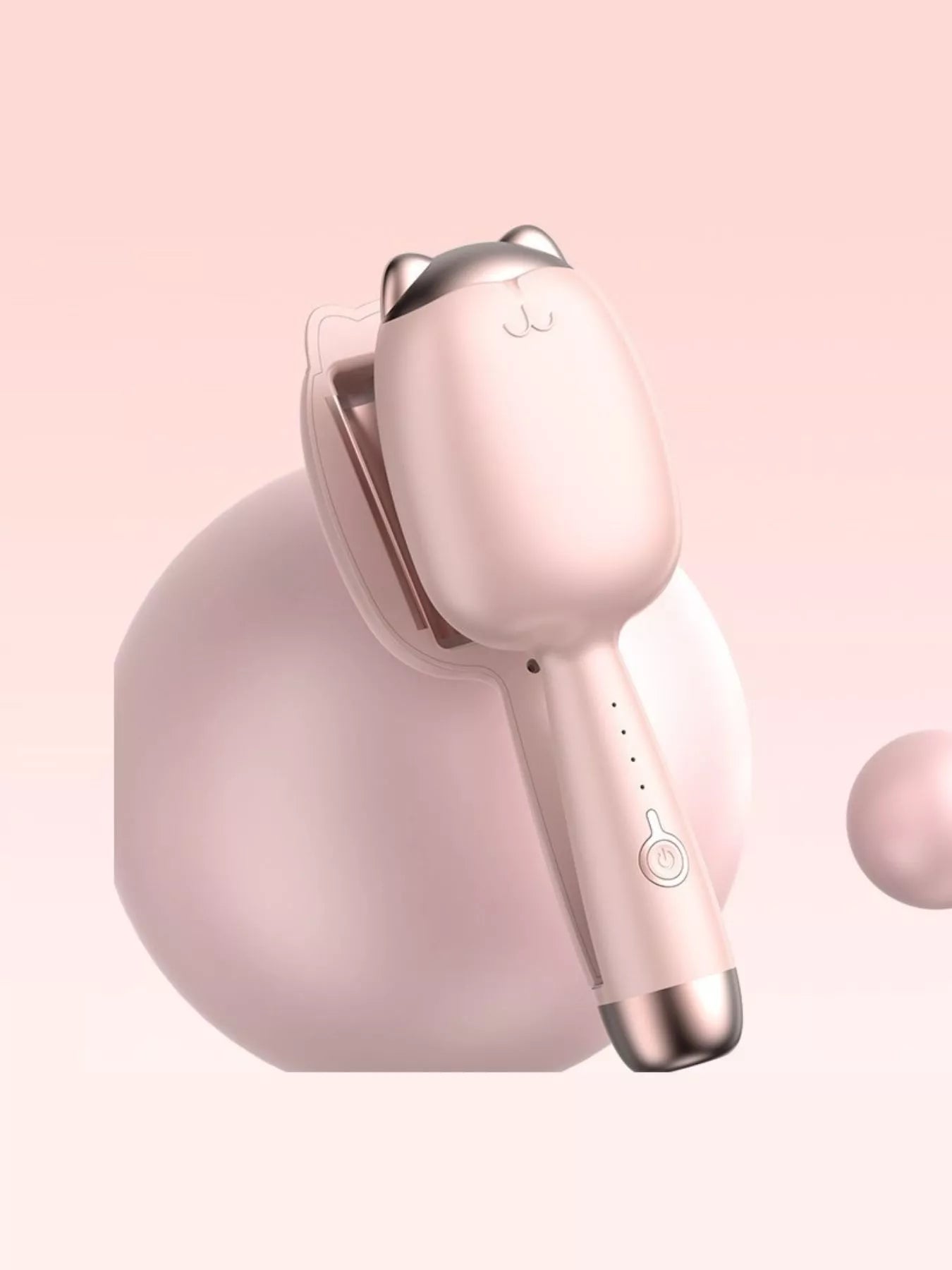 Pale Blush cat-shaped heated curling iron, close view of barrel and power button.