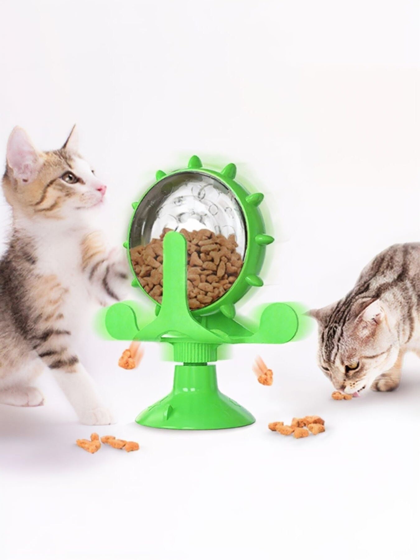 Interactive rotating cat treat toy with clear dome, green arms, and green base
