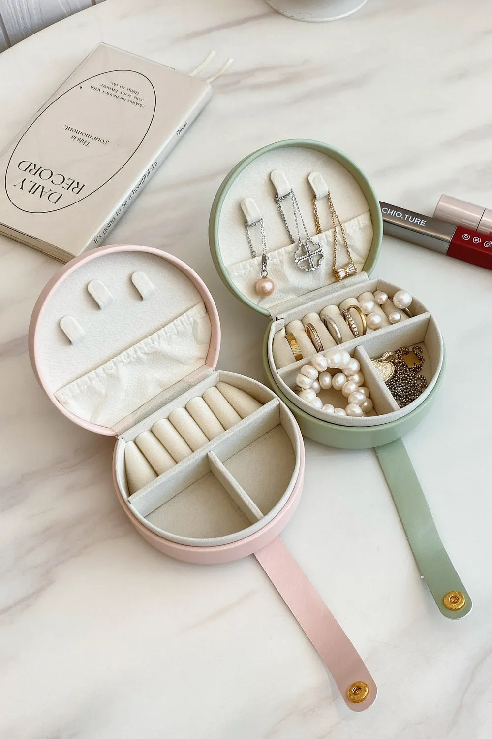 Set of round PU leather travel jewelry boxes in blush pink and gum leaf colors