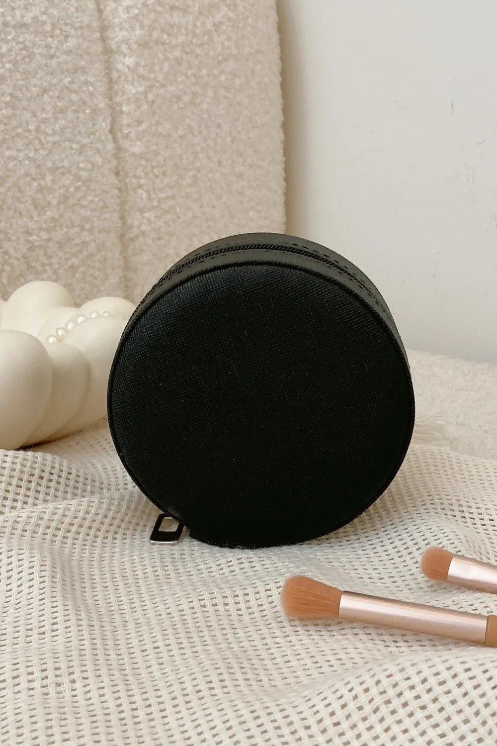 Black round PU leather jewelry storage box with zipper, compact carry case