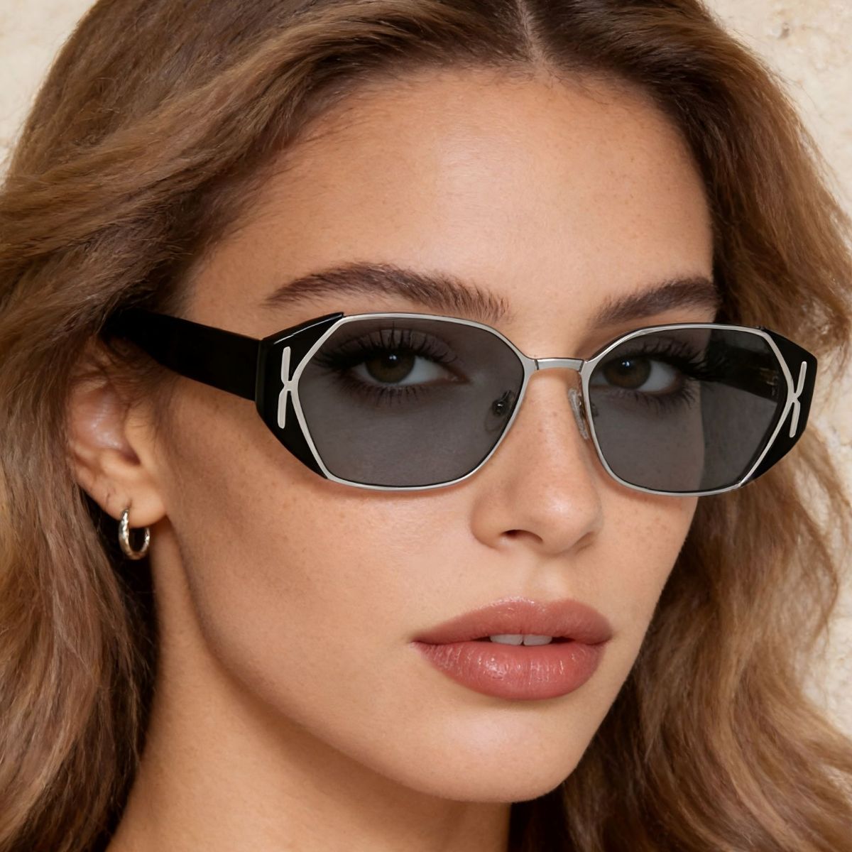 Geometric UV sunglasses, black frames with silver trim and dark lenses.