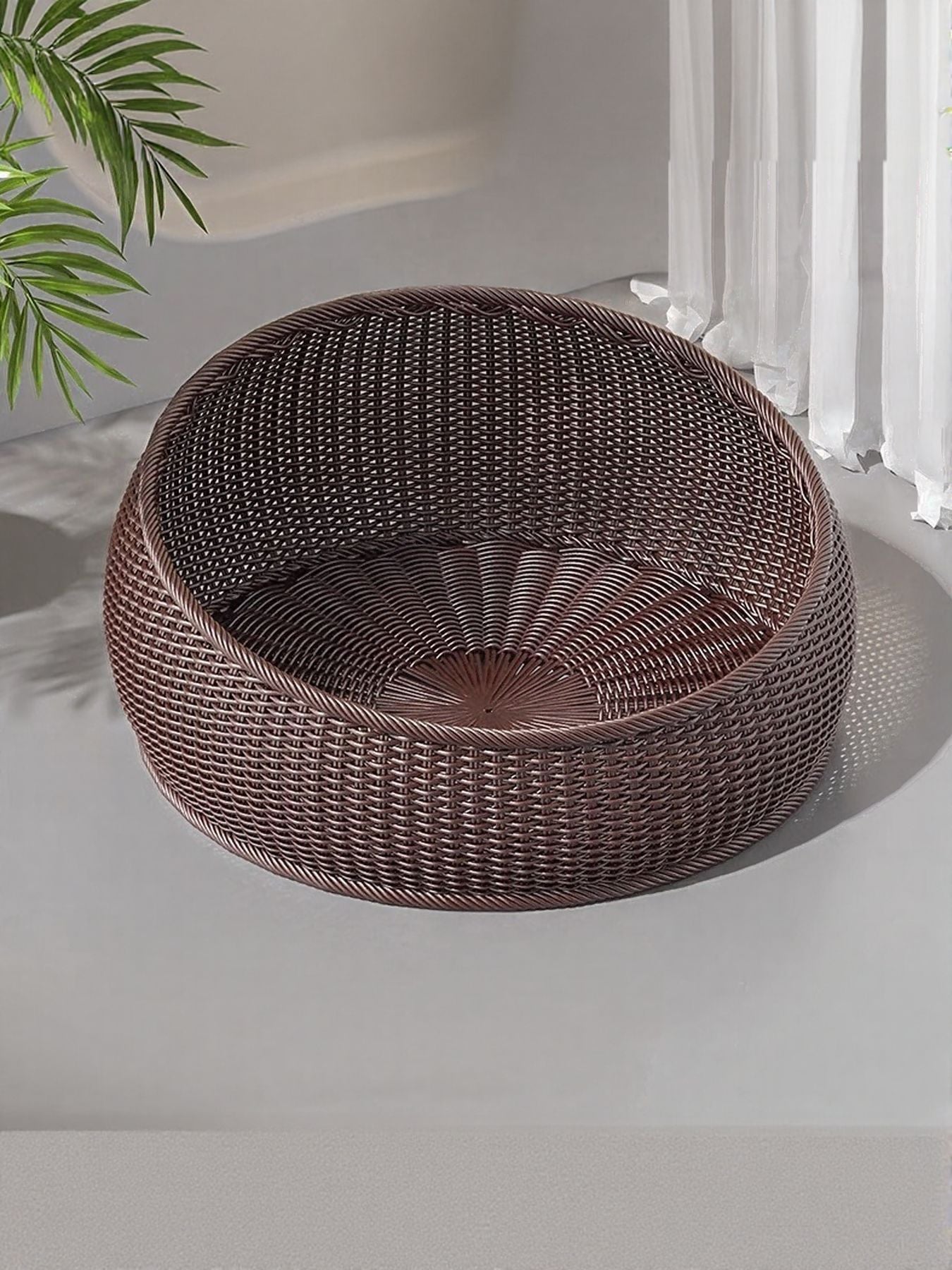 Brown round woven rattan pet nest with dark striped cushion lining