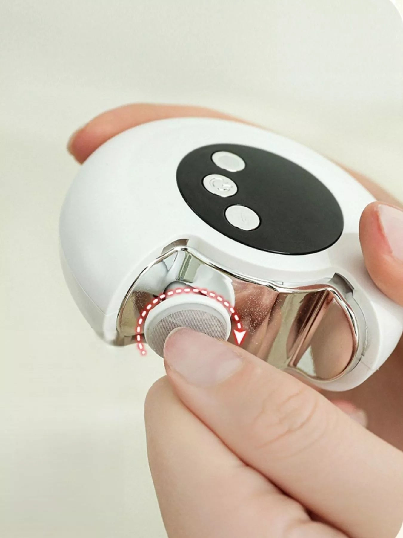 White portable nail buffer polisher close-up, removable metal head and black button panel